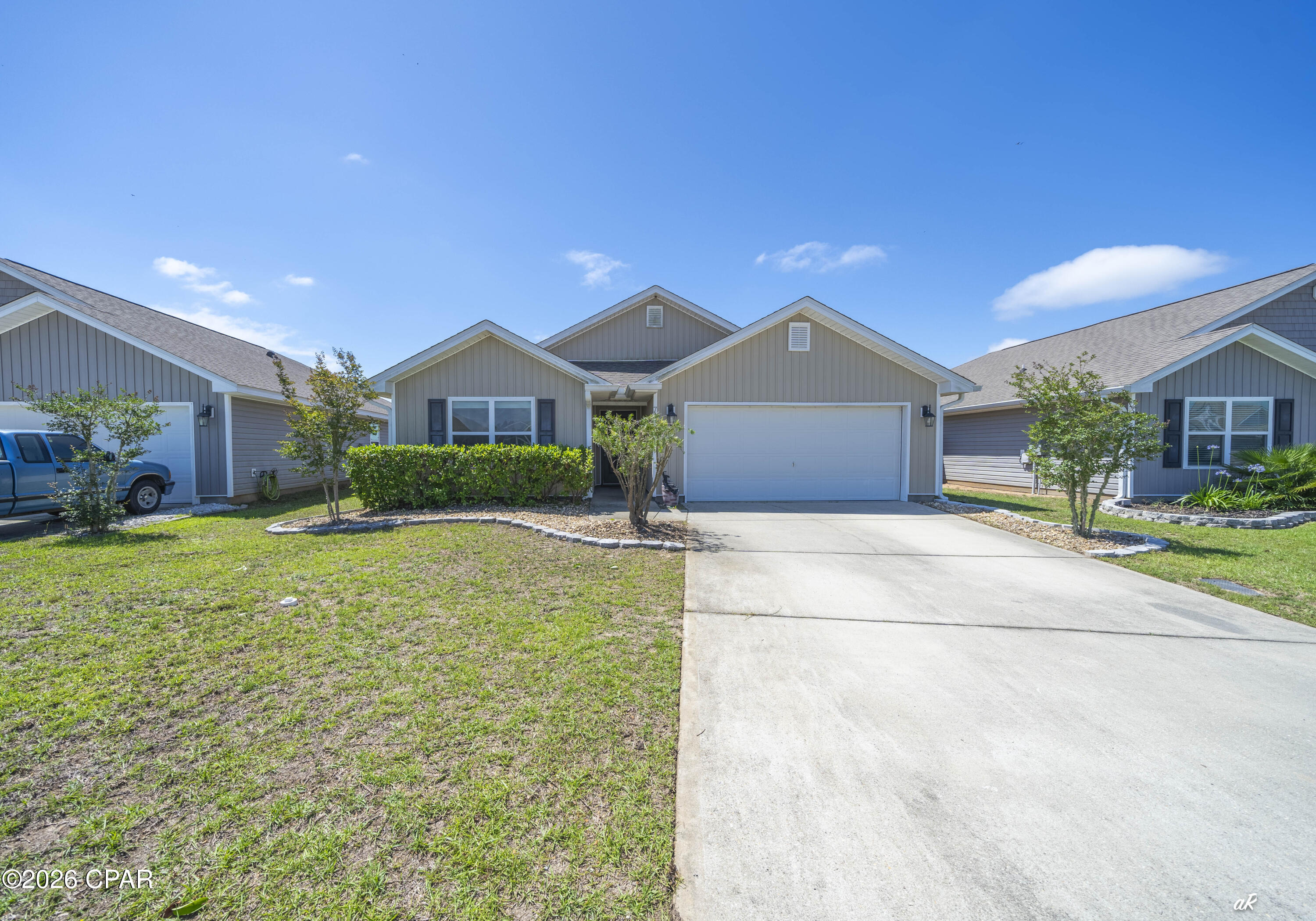 Welcome to this beautifully maintained 4-bedroom, 2-bath home at 7138 Hatteras Boulevard in the desirable Barrett's Park community, just north of Panama City. Combining modern features with everyday comfort, this home is move-in ready and designed for easy living. Step inside to an inviting open floor plan with durable laminate flooring flowing seamlessly throughout the entire home. The spacious living area is anchored by a stylish electric fireplace, creating the perfect focal point for relaxing evenings or entertaining guests. The kitchen and dining areas connect effortlessly, offering plenty of space for gatherings and daily life. The primary suite provides a comfortable retreat with multiple closets and double vanity sinks, while three additional bedrooms offer flexibility for family, guests, or a home office setup. Enjoy outdoor living year-round on the screened-in porch, complete with a hot tub--ideal for unwinding after a long day. Additional features include attic storage for extra space and the convenience of an included washer and dryer. There is a shallow well that is connected to irrigation so you can keep your lawn green all summer without the additional costs of metered water. Energy efficiency is a major bonus with solar panels that will be fully paid off at closing, giving you long-term savings and peace of mind. Located just minutes from shopping, dining, and the beautiful Emerald Coast beaches, this home offers both comfort and convenience in a growing area. Don't miss your chance to own this fantastic home--schedule your showing today!