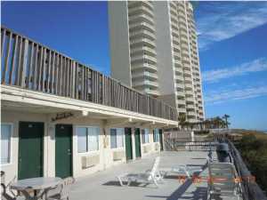 This is a Wonderful chance to have a Gulf front property at a reasonable price! The sand is just as white, the seas just as blue as the most expensive real estate on the beach! But here you get less density and more sand for yourself! Sit back and enjoy the money you saved! This property is legally structured as a ''cooperative.'' This is a low rise project with only two stories! Enjoy the pool, shuffle board, or just grill out on the balcony. Don't feel like cooking at home? Pier Park is just 200 yards to the west! This structure was a motel, converted to Cooperative form of legal arrangement, consists of a 330 Sq. Ft. efficiency unit, with kitchen area and bathroom. (NOTE: there is a land lease under the property with 34 years remaining, and the land lease is included in the monthly