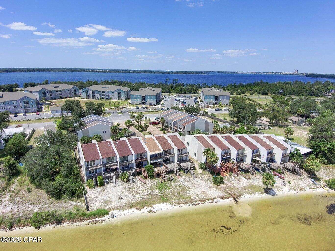 COMING SOON - NO SHOWINGS. Waterfront living with breathtaking views of East Bay. This spacious 2-bedroom, 2.5-bath townhome offers direct bayfront access, an oversized waterfront deck, and a private beach area just steps from your back door. Enjoy watching sunrises over the water, launching kayaks from the shoreline, or simply relaxing while taking in the panoramic bay views.

The home features, a 1-car garage and generous storage space beneath the deck for kayaks, paddleboards, or other water toys. Located in a quiet waterfront community just minutes from Tyndall Air Force Base, shopping, dining, parks, and public boat ramps.

Whether you're looking for a primary residence, second home, or investment property, this community allows long-term rentals and offers an exceptional waterfront lifestyle at an attractive value. Waterfront properties like this don't stay available for long.