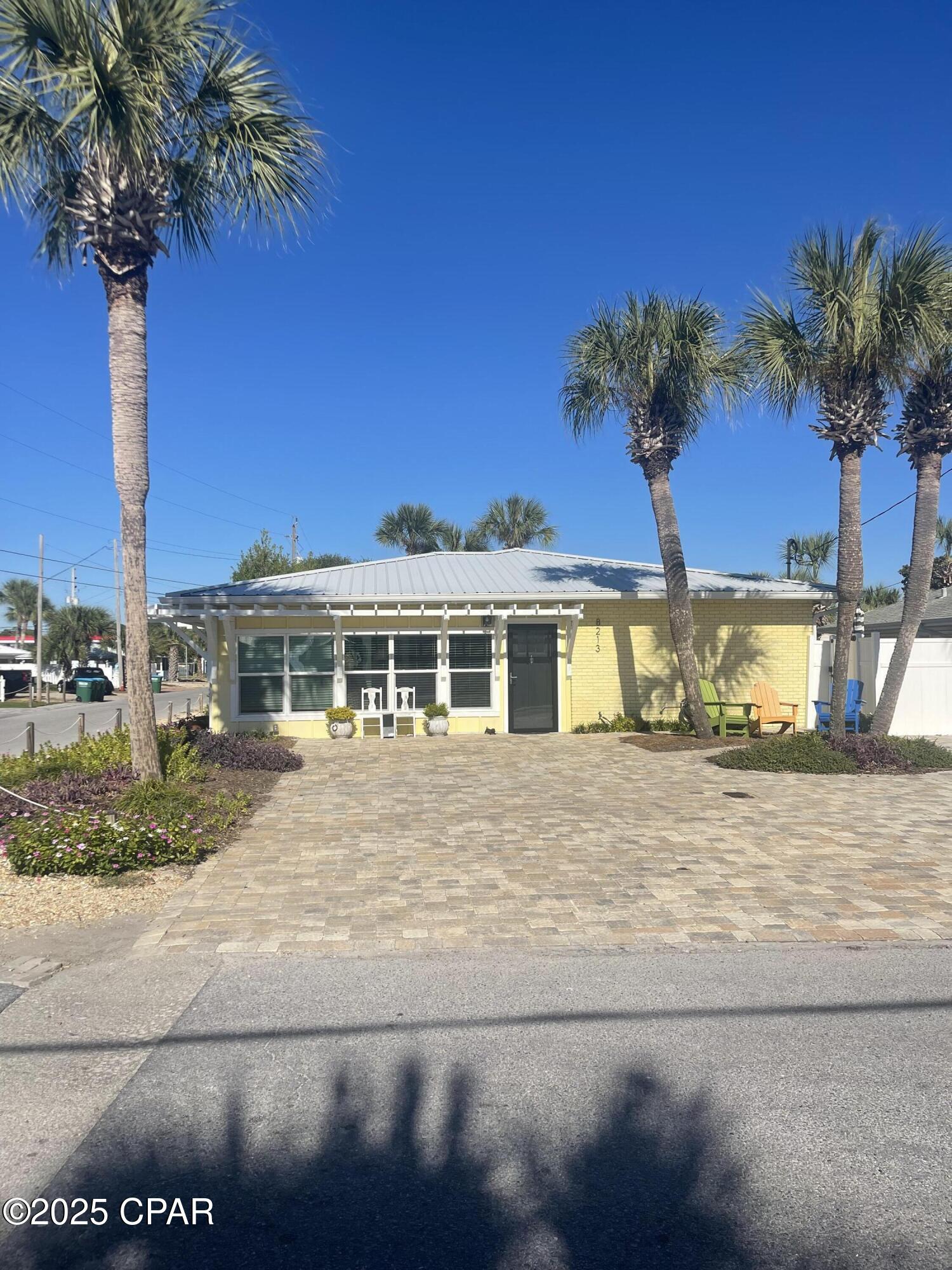 LOCATION IS EVERYTHING! Home is across the street from Beachwalk 19. You can be on the sand in one minute from the time you leave the driveway. The only thing that would be better is to be Gulf front and that would cost $Millions more. This home is in a very upscale area with many large gulf front houses within a block. This beautiful home was completely redone two years ago. All of the ceilings are shiplap and all of the flooring is LVP. Metal roof was done in 2019. There are gutters around the whole house.  The front of the house has a custom arbor that adds tremendous eye appeal. It is beautifully decorated and rental ready. Even though it has been a private residence, most of the furniture stays. It is on a corner lot with plenty of parking on the oversized stone paver driveway. The stone pavers are on both sides of the house leading to the large outdoor deck around the pool. There are outdoor tables and chairs that make for a great place to hang out. The heated swim spa is great for year round enjoyment. Half of pool is configured like a hot tub with seats and jets and half is like a pool. A new AC unit was installed earlier this year. In addition each bedroom has portable AC units so even in the hottest part of the summer, the bedrooms are more than cool. The open family room and kitchen area make for a great gathering place. There is a granite counter bar, that can seat at least 9, around the kitchen as well as a large table that can seat at least 10. There is a large screen TV in the family room as well as TVs in 4 of the bedrooms. One of the bedrooms is currently used as an office but would normally be used as a bedroom. The current bed configuration sleeps 16 but can easily sleep 18. All of the bathrooms have sliding glass doors with new tile around the whole shower. The hall bath has a new tub with tile around it along with the sliding glass door. The master suite has an extra large shower. The outdoor shower has cold and hot water. There are numerous hooks in each bathroom as well as around the outside shower to hold towels and swim suits. Everything in this house has been completely redone. The separate laundry room has full size stackable stainless steel washer and dryer  with amble storage shelves. The laundry room has an entrance directly from the pool area to manage all of the wet swim suits and towels. The bunk bedroom has sturdy large  built in wood bunks. 
Now is the perfect time to buy to be ready for the upcoming vacation rental season or to use as a second home or permanent residence. There is a white vinyl fence that surrounds the house.