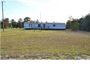 2.5 ACRES WITH UTILITIES!! This property comes with well, septic and power. There is an existing trailer on the property that could be rehabbed or scrapped. The value is primarily in the land. Build your dream home today. Spikes Road is Paved and only 12 miles to Lynn Haven or 16 miles to the International Airport. Zoned R-2 (Residential Single Family, Duplex or Manufactured Home) and Horses are allowed. School Zone: Deane Bozeman (K-12). Call today for your own private preview. All ages, sizes and measurements approximate; Information derived from seller & property appraiser's website, buyer to verify if important.