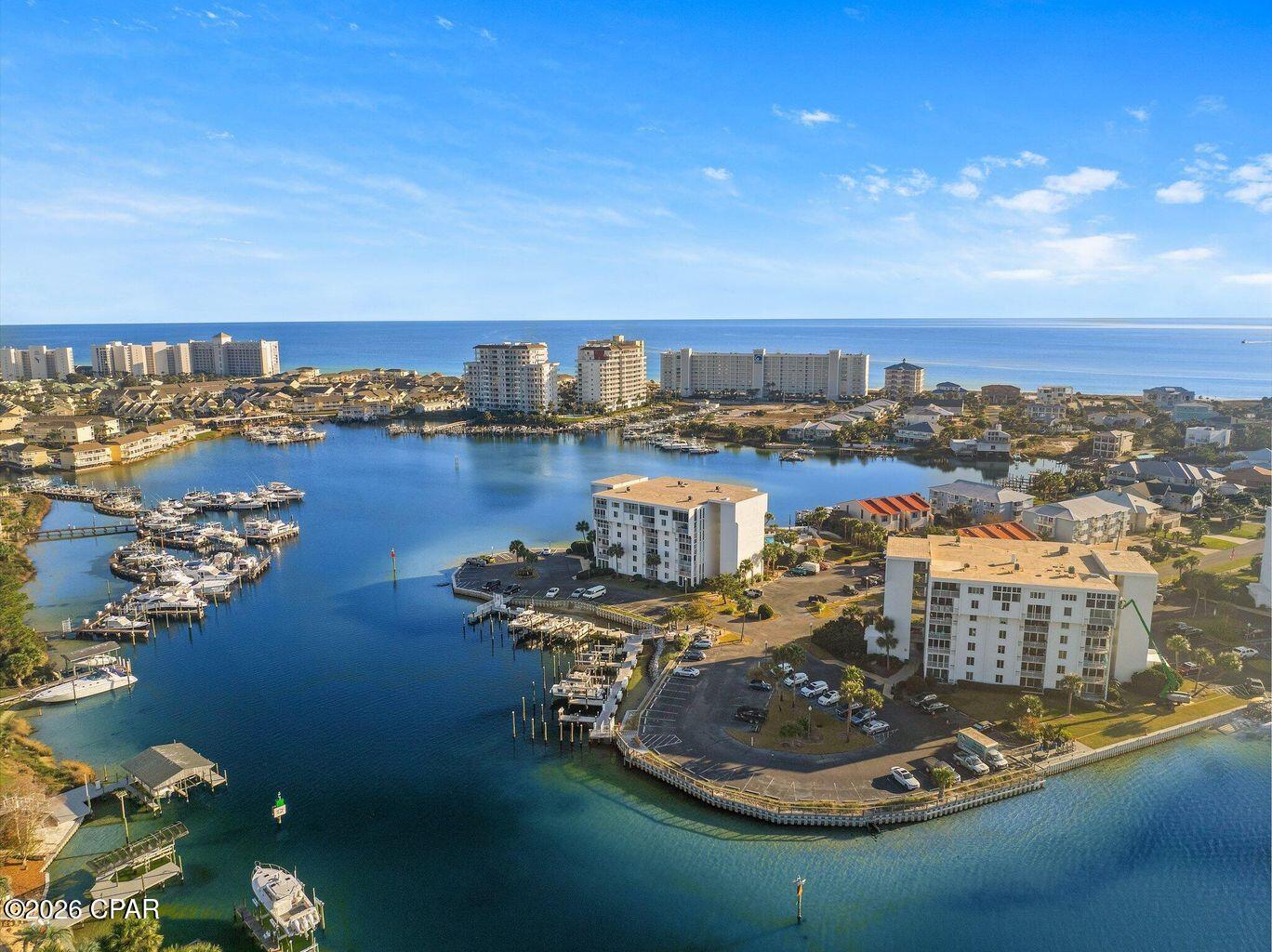 LOWEST PRICED DOLPHIN POINT CONDO BY A WHOPPING $40,000! That is an unbelievable deal for a Dolphin Point condo looking right out to toward the Gulf of Mexico. Discover the epitome of waterfront living in this immaculate 4th-floor condo at Dolphin Point, perfectly situated along Destin Harbor. This fully furnished and recently updated condo offers stunning panoramic views of Dolphin Point through expansive hurricane-proof windows and doors, installed in 2020. You can rest assured knowing that all milestone inspections were successfully completed.

Dolphin Point is widely recognized as one of the premier locations in Holiday Isle because of the vast views toward 3 points, Moreno Point, Destin Harbor, and the Gulf of Mexico. Boasting 2 bedrooms / 2 bathrooms and 1193 square feet, this condo offers plenty of space as a rental or second home for friends and family.

Nestled on Holiday Isle, this condo combines waterfront serenity with beachside convenience, including beach access just down Moreno Point Road. This sought-after condo boasts modern upgrades like granite countertops, new porcelain tile floors, a stylish new backsplash, stainless steel appliances, and an in-unit washer and dryer for added comfort. Dolphin Point offers an impressive array of amenities, including a marina, pool, tennis courts, and a waterfront clubhouse. Enjoy a private beach area overlooking Destin Harbor, along with dedicated storage for kayaks and paddleboards. Travel effortlessly along the Harbor with the Destin water taxi. The community is fully gated with approximately 42 security cameras already in place for added peace of mind.