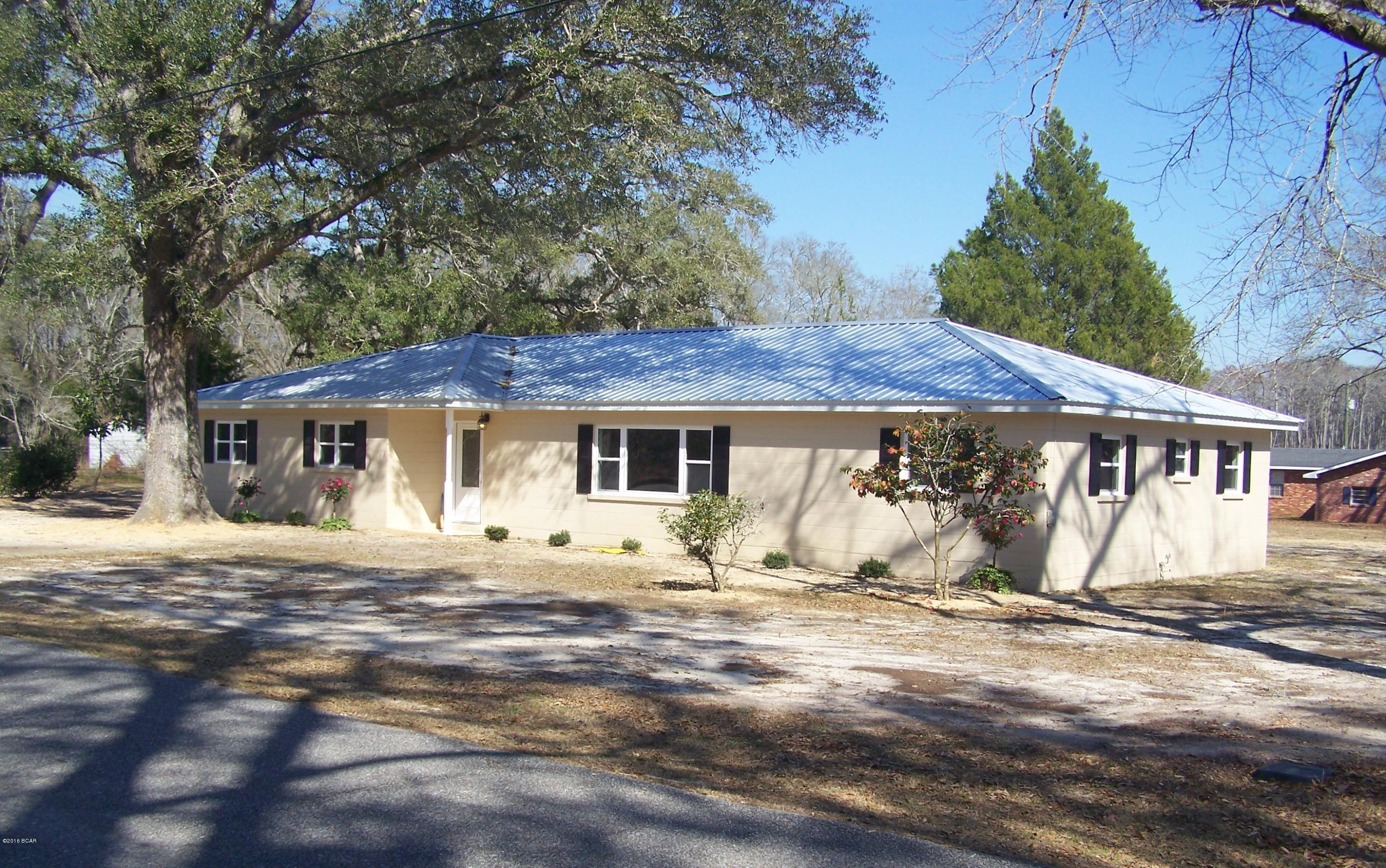 NEWLY RENOVATED, 4BR/2B, Home located in downtown Grand Ridge, FL.  This home looks and smells like a brand new home!  It has a new metal roof, new insulated windows, new interior and exterior doors, new hardwood laminate flooring, re-finished kitchen cabinets, new stainless sink, and beautiful new tile backsplash in kitchen.  The outside of the home is also freshly painted and has new vinyl shutters on the front and end windows.  This home is solidly constructed of concrete blocks, both on the inside and outside walls which should give it an additional wind rating during storms and should also make it less expensive to insure.  The inside has been freshly painted, as well, with a nicely textured finish.  Better bring you clients to see this one quickly, before it is under contract. This home also has new light fixtures and ceiling fans, a newer AC and Heat Pump unit, vinyl soffets, etc.  Come see this beautifully renovated home in Grand Ridge, FL.