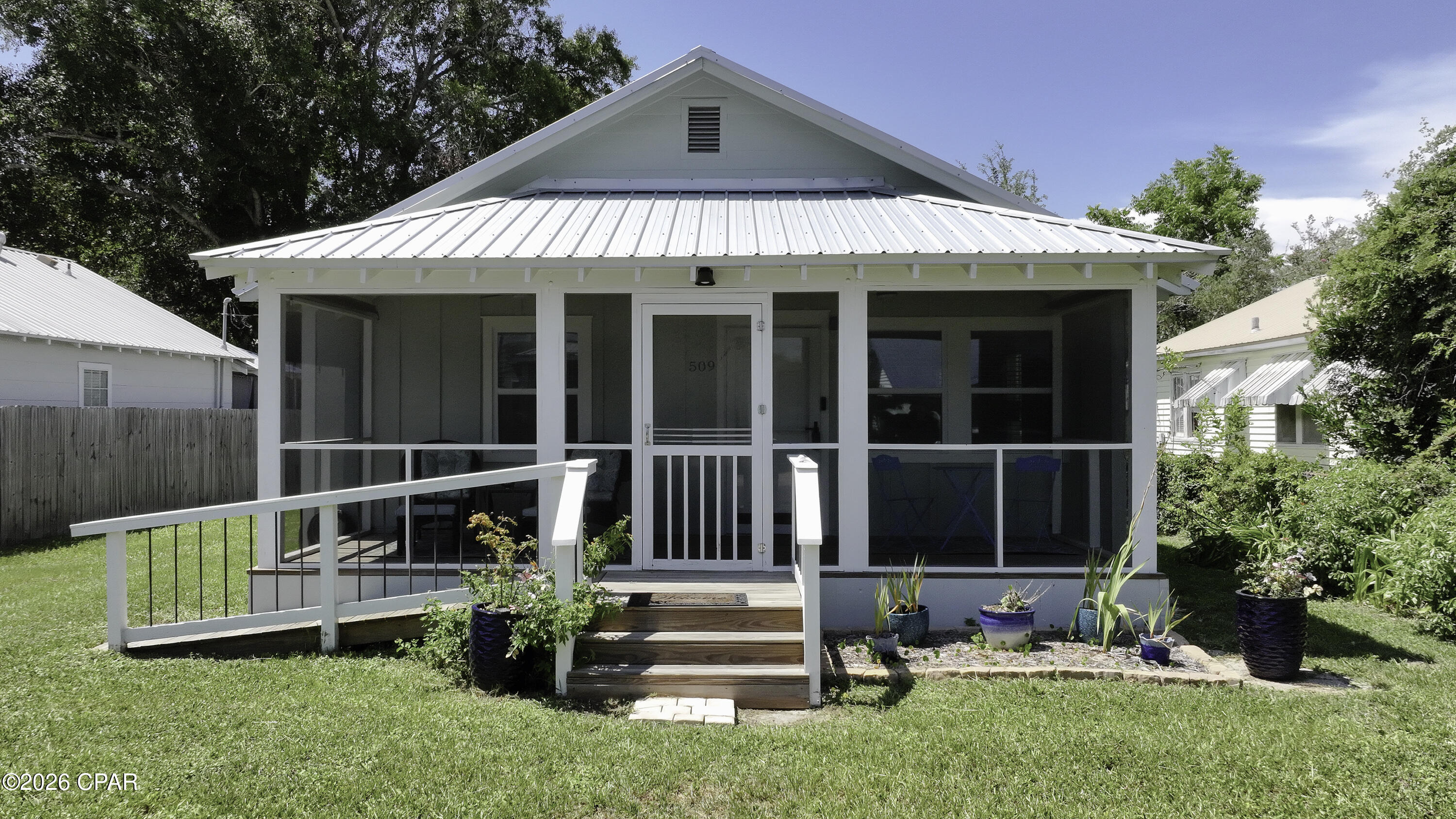 Turnkey Investment Opportunity with Two Short-Term Rental Eligible Homes! Whether you're looking to expand your investment portfolio, own a vacation getaway with income potential, or enjoy multi-generational living, this unique property delivers. Situated on a generous 0.20-acre lot just a short golf cart ride from downtown, this offering includes a beautifully renovated 2BR/2BA main home (1,254 SF) and a separate 2BR/1BA accessory dwelling (660 SF)--both eligible for short-term rentals.  Both homes have been thoughtfully updated and are offered completely furnished, making this a true turnkey opportunity. Recent improvements include a new metal roof, new flooring, updated interiors, modern kitchens, and refreshed bathrooms. The main home features an inviting covered front porch, an open-concept living area, abundant natural light, and a stylish kitchen with stone countertops, gray cabinetry, stainless appliances, and a center island perfect for entertaining.  The detached accessory dwelling provides exceptional flexibility for guests, extended family, or additional rental income. A privacy fence separates the two residences, allowing each home to enjoy its own space.  With multiple parking spaces, bay views from the road, and strong income-producing potential, this property is ideal for investors, second-home buyers, or owner-occupants who want to live in one home while generating income from the other. Rare opportunities like this don't come along often.