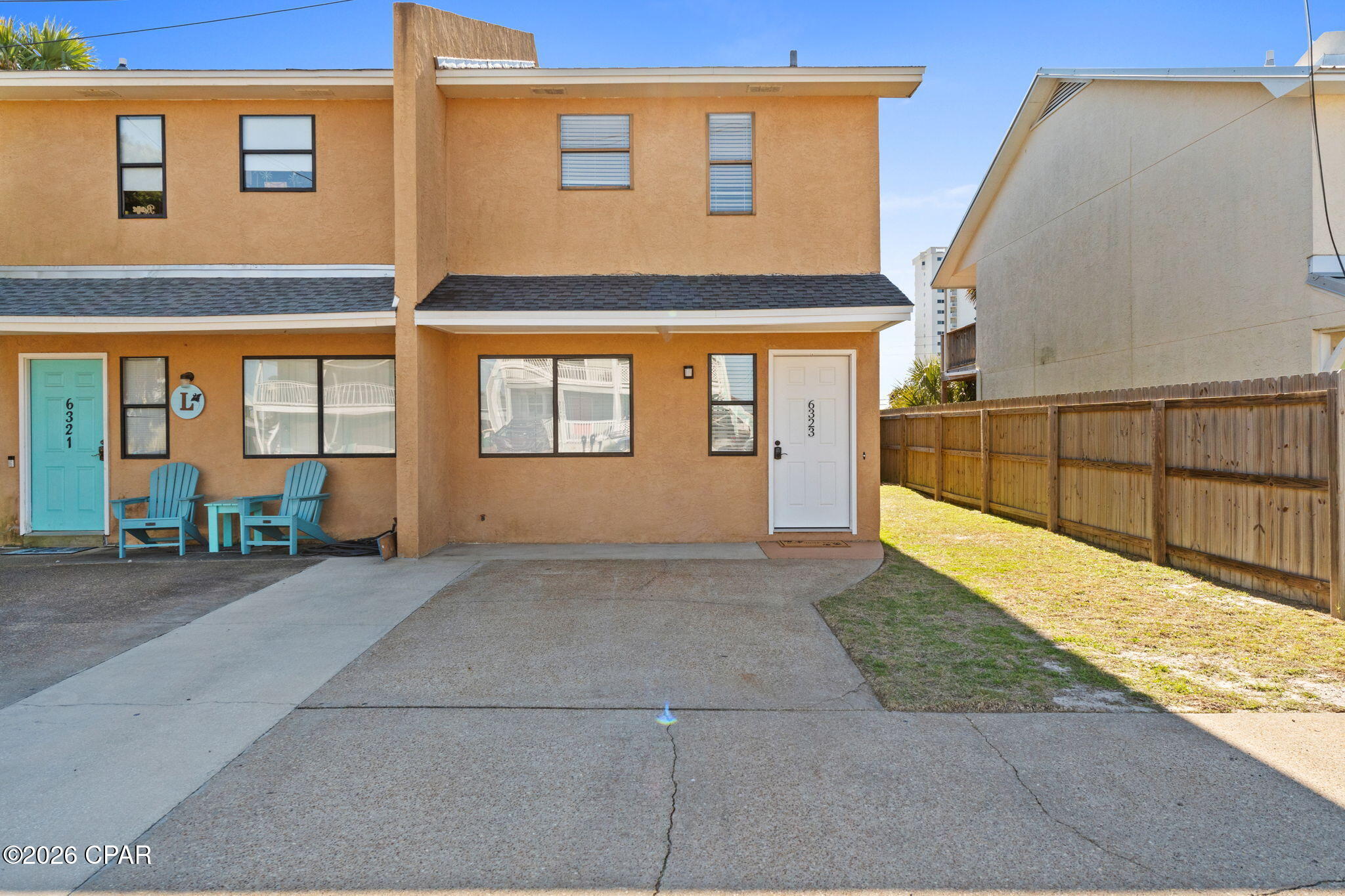 Welcome to 6323 Beach Drive in Panama City Beach Florida. This adorable 2-bedroom, 2-bath townhome is just blocks from three public beach access points and the emerald-green waters of the Gulf! From the moment you arrive, you'll love all the benefits this home provides --private parking, a low-maintenance fenced yard, and no HOA. 
The first floor includes 2 bedrooms and 2 full bathrooms, convenient laundry closet, and abundant storage space. Step out the back door to an ideal spot for entertaining and enjoying the beautiful weather and ocean breeze. There's also an outdoor storage closet for all your beach gear and other outdoor essentials. The second floor boasts an open concept kitchen that flows into a spacious dining and living room with ample natural light. An expansive covered deck awaits just past the back door, offering a front-row seat to breathtaking sunset views. Being sold fully furnished and rental-ready, this home is truly turnkey -- ready to move in, rent out, or enjoy as your private beach escape. This property affords income potential as well as a relaxing personal getaway. Located on Thomas Drive, this peaceful area is known for its convenient sidewalks, family-friendly atmosphere, and proximity to the best of Panama City Beach -- including St. Andrews State Park, Pier Park, marinas, local restaurants, golf courses, and shopping. Don't miss your chance to own a piece of paradise. Whether you're searching for a primary residence, second home, or investment property, this townhome checks every box.