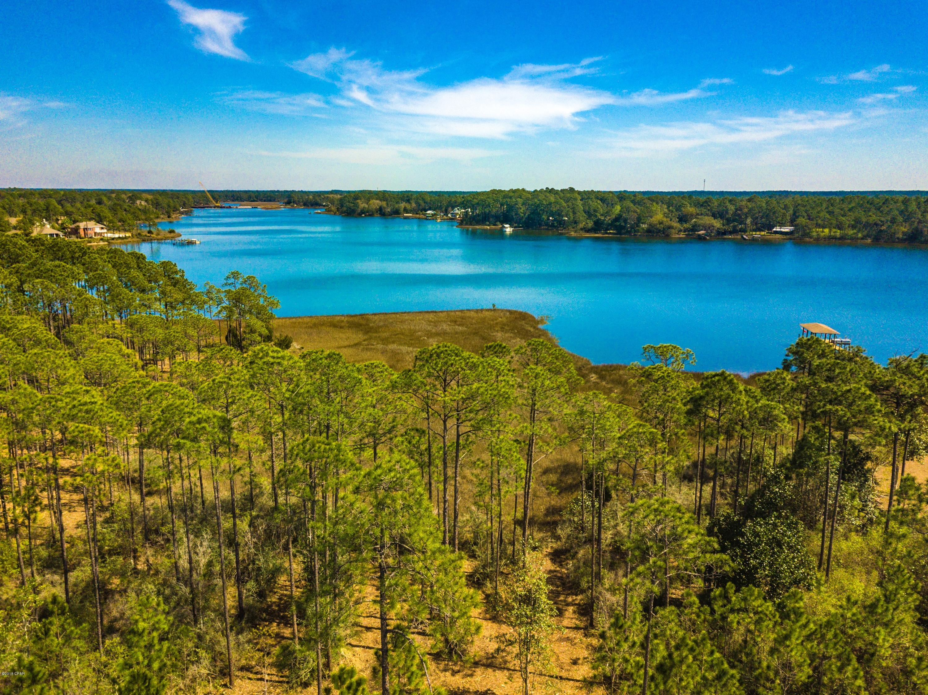 Serenity awaits on the beautiful residential lot in the popular gated Laird Bayou subdivision. This waterfront lot has direct access to the Gulf of Mexico, deep sea fishing, Shell Island and the world's most beautiful beached. Amenities of the neighborhood include pool, pool house with parking, bathrooms and lockers, community boat ramp and dock, gated community RV and boat storage. The owner has already thoughtfully cleared the lot so it is easy to access, walk and view the panoramic waterfront views.