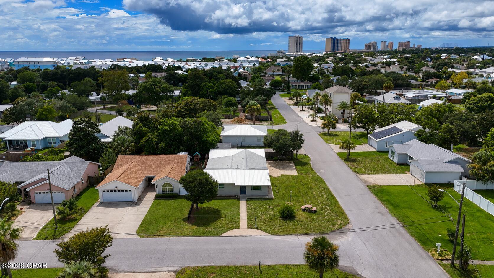 Major Price Reduction! Motivated Seller! 

Welcome to this charming 2-bedroom, 2-bath beach cottage situated on a spacious corner lot in a quiet, family-friendly neighborhood just minutes from the Gulf. Full of classic Old Florida charm, this home showcases original terrazzo floors and vintage tile while offering numerous modern updates, including newer appliances, HVAC system, water heater, doors, windows, crown molding, and an attractive metal roof. The kitchen is highlighted by a stunning custom stained-glass window that creates a warm and inviting focal point. A versatile sunroom provides the perfect space for a home office, playroom, guest room, or additional living area to fit your lifestyle. Just off the garage, the unfinished bonus room offers endless possibilities as a workshop, craft room, hobby space, or storage. Located in a desirable neighborhood with no short-term rentals, you'll enjoy a peaceful setting while remaining close to everything Panama City Beach has to offer. The home is conveniently located near Hutchison Beach Elementary School, Surfside Middle School and Arnold High making it an excellent choice for families. You'll also have quick access to Hutchison Boulevard and Panama City Beach Parkway, placing Pier Park, Dolly Parton's Pirates Voyage Dinner & Show, Topgolf, shopping, dining, and entertainment just minutes away. Best of all, you're only 0.5 miles from the sugar-white sands and emerald waters of the Gulf of Mexico. Whether you're looking for a primary residence, second home, or beach retreat, this property offers the perfect blend of charm, location, and flexibility. Schedule your private showing today! All measurements, dimensions, and information are approximate and should be verified by the buyer if important.
