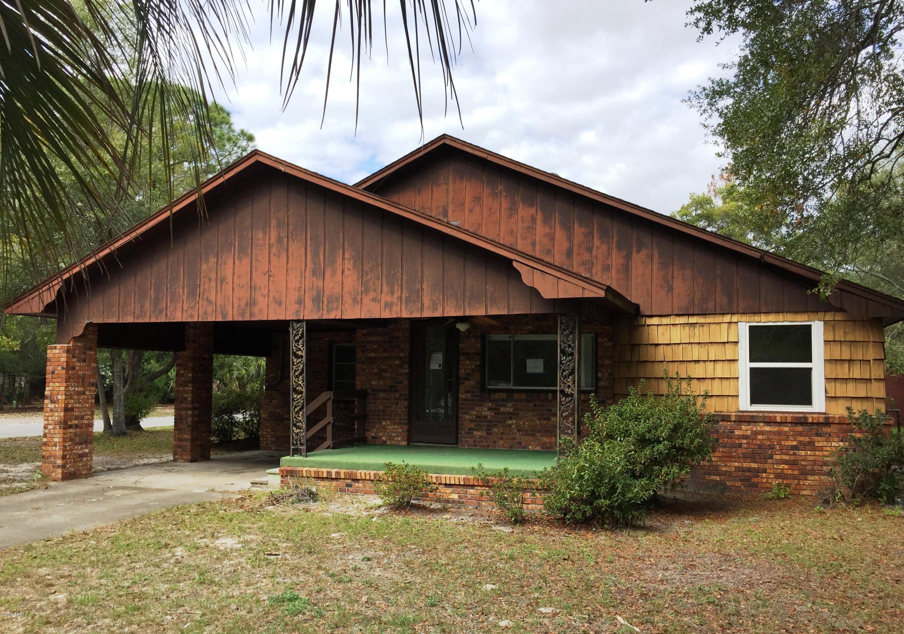Large corner lot with fenced in back yard. This home has lots of room inside! The spacious living room has a wood burning fireplace and the family room has wood floors. There is also a formal dining room and the bedrooms are spacious. The home could easily be made to have an efficiency or mother in law suite as the master suite has its own entry from the backyard. There is also a yard building offering plenty of storage space. Put your hammock on the large front porch and park your toys and vehicles in the oversized carport and large driveway space.