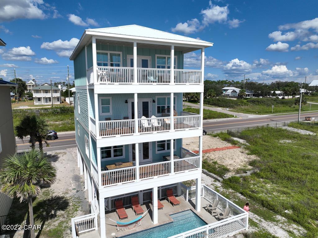 IMPRESSIVE 5BR/4BA GULF FRONT HOME W/PRIVATE POOL IN ST JOE BEACH! Wall-to-wall windows capture waterfront views enriching the open concept living/dining/kitchen space. SS appliances, granite tops & an ornate backsplash create a classic kitchen design. Included on the main level is a covered deck for entertaining & a BR suite. Upstairs is a Jack & Jill BA joining 2 BR along w/the primary suite w/private gulf side deck. The elevator extends to the top level for hotel inspired lodging w/sitting area & French doors leading to the sundeck. Guests' will enjoy a soaking tub, separate rain head shower stall & double vanity. Updated w/trendy wallcoverings, shiplap accent walls & seaside inspired light fixtures. Take the 3D tour & call to view this amazing home!