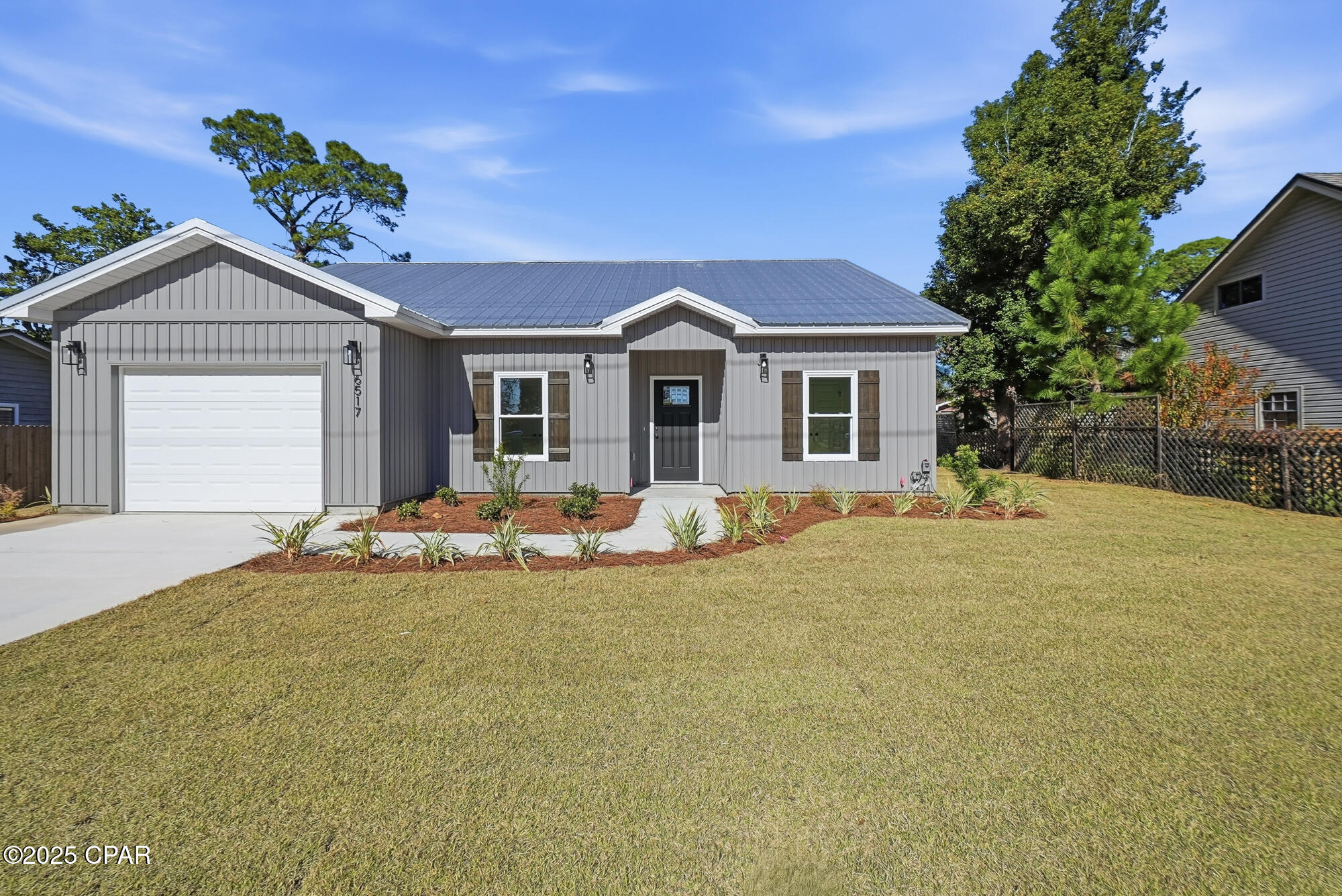 BIG PRICE DROP- CONSTRUCTION COMPLETE on this BEAUTIFUL NEW HOME in a CONVENIENT BEACH LOCATION! This CRAFTSMAN STYLE HOME LIVES LARGE!  It's hard to find  a new home at this price on the EAST END of the beach! Located just minutes from  the NAVY BASE, ST ANDREW STATE PARK, PUBLIX, GREAT RESTAURANTS AND TOP SCHOOLS!! 
The exterior features a CHARMING BOARD and BATTEN STYLE SIDING with WARM RUSTIC SHUTTERS. A covered entrance leads to an inviting OPEN FLOOR PLAN featuring 9 ft ceilings and 10 ft decorative trays, maximizing the square footage! There's a spacious kitchen with loads of storage, BEAUTIFUL CRAFTSMAN STYLE CABINETRY, UPGRADED BLACK STAINLESS APPLIANCES and WHITE QUARTZ COUNTERS. NEW CONSTRUCTION means years of worry-free living and LOW INSURANCE RATES! This nicely landscaped home includes a sprinkler system and best of all, NO HOA's and NO REQUIRED FLOOD INS !! SELLER HAS NEW SURVEY and HOME INSPECTION FOR A BUYER.