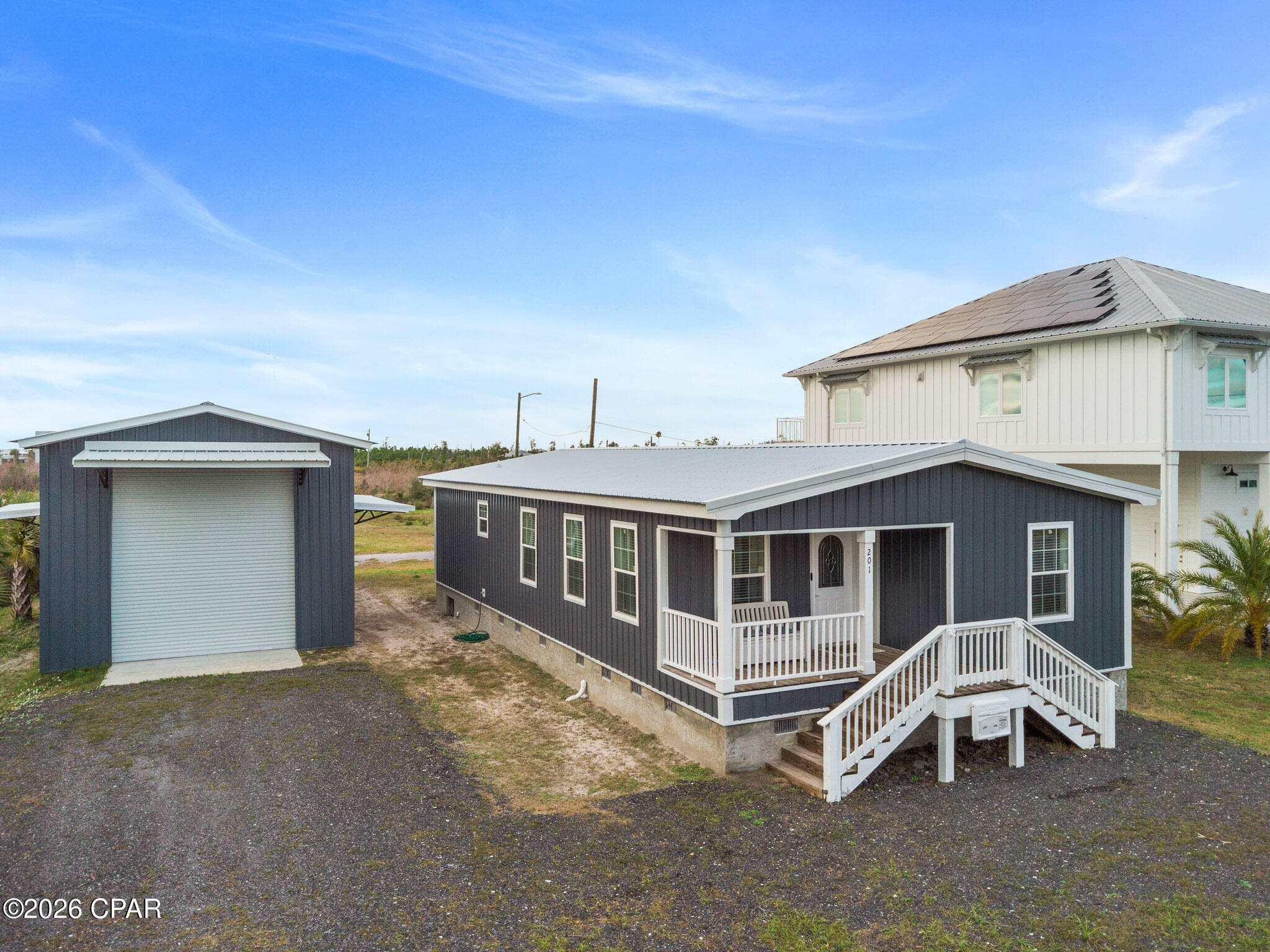 Located in Florida's scenic Panhandle, Mexico Beach sits perfectly between Panama City Beach (approximately 45 minutes west) and the quiet coastal charm of Port St. Joe (10-15 minutes east). Nearby favorites include Cape San Blas, Indian Pass, and the historic town of Apalachicola.

You'll love this 4-bedroom, 2-bath modular home situated on a large lot within walking distance of the white sandy beaches of Mexico Beach. Built for coastal durability, the home features a new metal roof and metal siding, along with a cozy covered front porch—perfect for enjoying relaxed beach days.

Inside, the home offers a bright, open floor plan filled with natural light. The spacious kitchen is a standout, featuring abundant cabinetry, generous counter space, and a massive 4x8 island, ideal for gatherings and entertaining. With four bedrooms, there's plenty of room for family getaways or hosting guests.

A major bonus is the 50x20 shop, perfect for RV or boat storage, complete with three roll-up doors, 15-foot trusses, and plumbing in place for an additional bathroom.

Conveniently located near Mexico Beach, Port St. Joe, and fishing along the Apalachicola River, this property is ideal as a retirement home, weekend retreat, or coastal getaway.