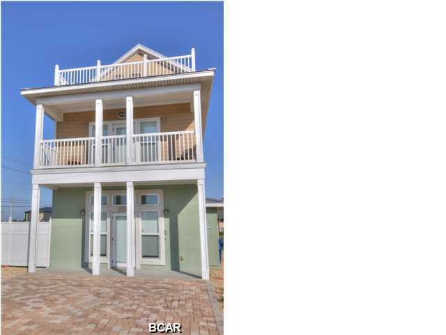 Four bedroom, 4 bathroom beach house in Panama City Beach! Conveniently located on the beach side of Thomas Drive & only 1 block to closest beach access! Open living area. Kitchen features custom cabinets, stainless steel appliances, granite counter tops, & breakfast bar. The Master Suite is located on second floor, with private balcony overlooking Cobia St, & a fabulous bathroom with double vanities, glass shower, & separate tub. Guest bedroom on the first floor has an adjoining bathroom. The guest bedroom on the second floor also has an adjoining private bathroom. The spacious third story living area features a full bathroom & has access to the sun deck. The fully fenced backyard has a salt water plunge pool & plenty of grassy space.