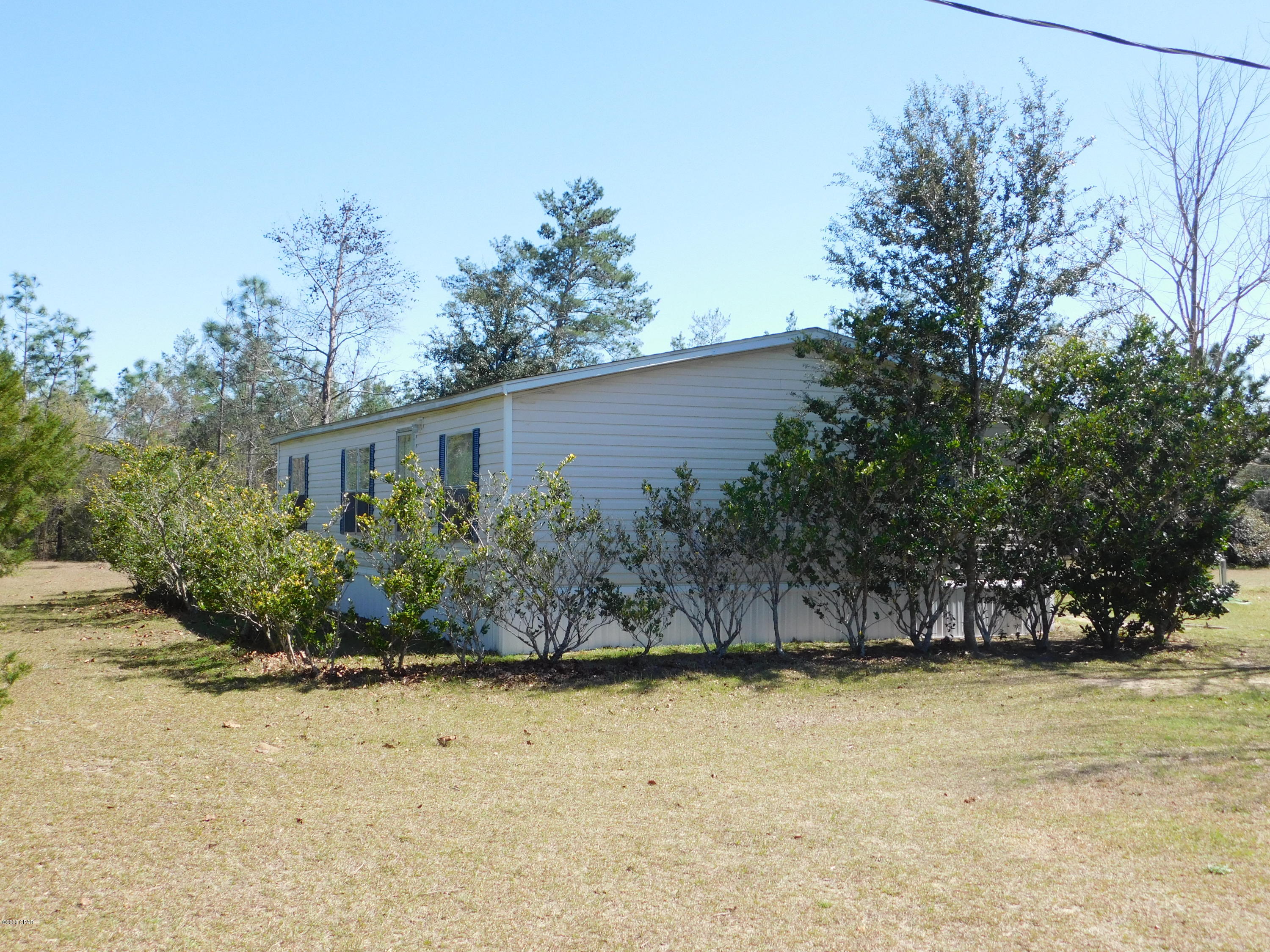 Well maintained 3/2 dwmh on 6.23+/- acres located in SE Washington Co.  Home offers a kitchen/dining area, pantry. Spacious living room. Split floorplan has master bedroom, master bath with double vanity, garden tub, separate shower and walk in closet. Additional 2 bedrooms and full bath.  Back deck great for BBQ's. Fencing in place. 24'x40' pole barn. Plenty of room for all! Approx 30 min to Chipley and 50 min to Panama City.