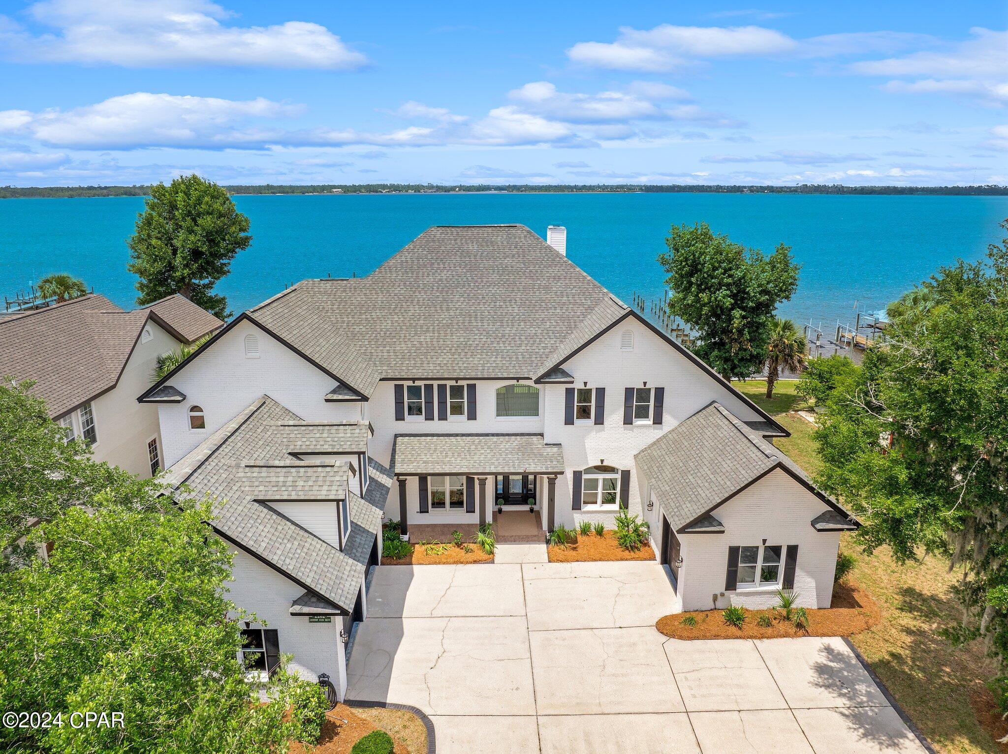 Discover the epitome of waterfront elegance in this luxurious two-story residence nestled within the prestigious Panama Country Club in Lynn Haven, Florida. Boasting an impressive 5,502 square feet of meticulously designed living space, this exquisite home offers a seamless blend of sophistication and relaxation. From the moment you arrive, you'll be captivated by the stunning panoramic views of the water, setting the stage for a lifestyle of unparalleled luxury.

Indulge in the ultimate waterfront experience with your very own private deep water dock featuring a convenient boat lift, allowing for effortless access to the serene waters of St. Andrews Bay and direct Gulf of Mexico access. After a day of boating and exploration, retreat to your own personal oasis and unwind in the inground spa, enveloped by the tranquil sounds of the waterfront. Whether you're hosting gatherings in the spacious living areas, enjoying al fresco dining on the patio, or simply soaking in the breathtaking views from the primary suite's private balcony, every aspect of this magnificent home is designed to elevate your waterfront living experience to new heights. Don't miss this rare opportunity to own a piece of paradise in the Panama Country Club.   
Contact your favorite agent today!