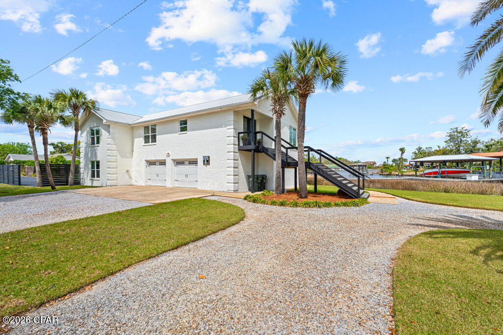 Welcome to this stunning, fully remodeled five bedroom, three bath home in the heart of Lynn Haven offering over 3,400 sq ft of luxury living. Vaulted ceilings with gorgeous tongue and groove wood detail set the tone, while sweeping panoramic water views steal the show from the kitchen, living room, dining room, and primary suite. Unwind on your private upstairs balcony as you take in breathtaking sunrise views, or head down to your private dock and boat lift, yes, the boat can even be included with the right offer!  The lower level is built for entertaining with an incredible media room featuring a projection screen, TV, and a full kitchenette perfect for movie nights, game days, guests, or multi-generational  or even in-law living.   And just when you think it can't get any better... step outside to your very own pickleball court! 

All of this sits on nearly half an acre at the end of a quiet dead end street, offering the perfect combination of privacy, space, waterfront living, and unforgettable views.