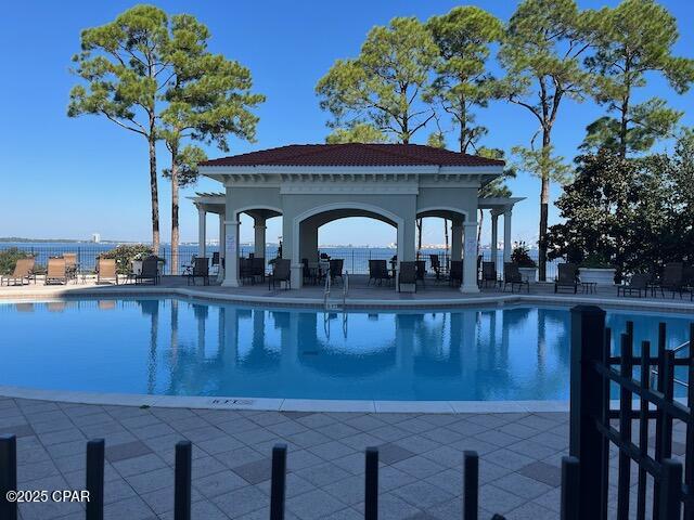 Welcome to Magnolia Bay Club, A popular gated waterfront community on St Andrews Bay in Upper Grand Lagoon. This rare 4 bedroom, 2.5 bath home is the largest floor plan in this community and features beautiful hardwood floors, tile, crown molding, a large living room with a cozy fireplace and custom plantation shutters. There is a large formal dining room that could also be used for an additional family room or other living space. The kitchen boasts stainless steel appliances, granite countertops, new gas stove, breakfast bar, upgraded Bisque Cabinets, breakfast nook, new tankless water heater, the lists goes on. The master bedroom is located upstairs which allows for lots of living space on the first floor. The oversized master has hardwood floors, a large walk-in close and a master bath with a garden tub, walk-in tile shower and new quartz double vanity. There are 3 spacious guests bedrooms and very large guest bathroom. One of the bedrooms is currently being used as a hobby room with hanging cabinets and custom work table. Several upgrades can be found throughout this well appointed home, including new cabinet and door hardware, vanity lights and faucets. The front porch is very welcoming and has room for a swing. Made for entertaining, the back terrace has beautiful pavers and black steel fencing. You will have ample room in the garage for 2 cars and storage. Another custom feature  this home is a 2nd attic space and insulated ceiling in the garage. New roof 2018, new tankless hot water heater 2024, new gas range 2025, new air handler for the HVAC 2023. No worries about lawn maintenance - mowing , trimming, irrigation, fertilizer and yard pest control all taken care of by HOA dues.  Magnolia Bay Club is a rare gated community on St Andrews Bay with a well maintained neighborhood, playgrounds, amazing pool and patio overlooking the bay, exercise room, lovely community clubhouse, and pier on the bay. Move in ready, must see to appreciate, schedule your appointment today! *Chandeliers do not convey*All information dimensions, sizes approximate and Buyer is to verify all information for accuracy