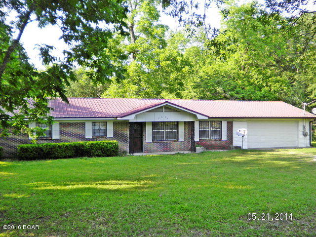 This brick home in town is a very good investment at this price, tile floors, new bathroom, new kitchen counter tops, new stainless appliances, new built in microwave, new paint throughout,all new doors,new light fixtures,new ceiling fans, very open and spacious, with french doors leading to a bonus room or could be used as a family room, metal roof, over an acre lot in town, large two car garage with electric door opener, security doors and bars on windows that professionally installed on all windows and doors. Large spacious back yard with plenty of shade and privacy. Very easy to show, coded lock box call agent to show.