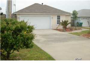 Fantastic beach location; golf cart friendly community!! This house is turn key and in excellent condition. Brand new roof has a 25 year warranty, all of the mechanical components are energy efficient and were installed within the past five years or less. The living room has a wood burning fireplace, there are new sky lights, cathedral ceilings, sprinkler system, double car garage, hard wood floors, new tile, new carpeting and freshly painted inside and out. The garage was freshly painted and has a large workshop space on the left side with shelving units. The back yard is completely fenced with an 8 foot privacy fence. The covered patio is lined with sun fabric that cuts down 70% of the suns rays. The outside deck is maintenance free as it was built with trex boarding composite