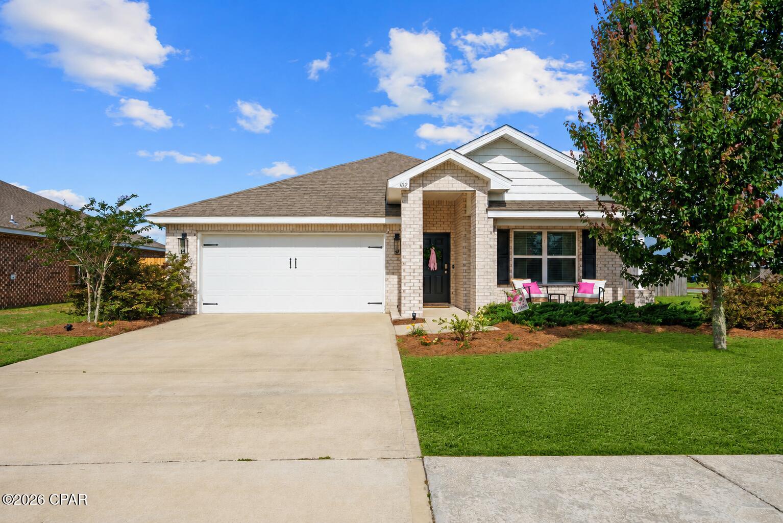 OPEN HOUSE Sat. 5/23 & Sun. 5/24 from 1 to 3pm - STOP scrolling and look inside 102 Spike Circle where thoughtful upgrades, timeless finishes, and exceptional outdoor living set this home apart from the typical builder-grade experience. Located on a rare corner lot in Hodges Bayou, this exceptionally maintained 4-bedroom, 2-bath Cali floor plan offers 1,788 square feet of comfortable living space on an oversized .241-acre lot with added privacy.

What makes this home unique is that it's ALL BRICK (all 4 sides) in a community where the builder is no longer building full brick homes. Additionally, this light-colored brick home also features a charming front porch and brick columns that are no longer standard for the Cali floorpan in Hodges. - Inside, you'll find upgrades that elevate the home such as LVP flooring, granite countertops, a classic kitchen backsplash, luxury style lighting and hardware,  custom board-and-batten accents, a spacious walk-in pantry, and a large primary suite with an impressive walk-in closet. The split-bedroom layout provides excellent privacy between the primary suite and guest bedrooms.

The backyard is where this property truly stands out!  Custom pavers, a covered gazebo, and a privacy-fenced yard create the perfect space for entertaining, summer barbecues,  or simply relaxing outdoors. These custom upgrades add both character and value rarely found in comparable homes.

Conveniently located less than 5 minutes from Lynn Haven Bayou Park & Preserve and just 2 minutes from a public boat ramp, this home combines everyday comfort with easy access to some of Bay County's favorite outdoor amenities.

BONUS: In addition to the ALL BRICK exterior & custom backyard additions,  the refrigerator, washer, dryer, blinds, and all window treatments convey-- VALUABLE EXTRAS not included with most new construction homes in this community.  *The first front photo of the home is virtually enhanced.