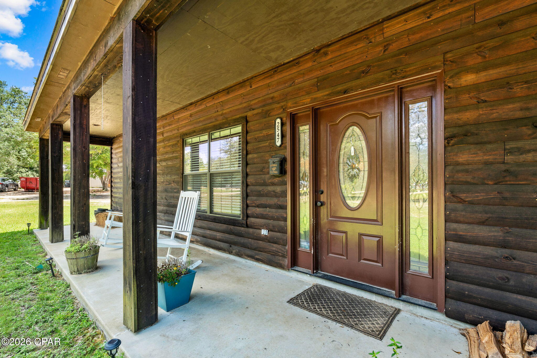Welcome to 2547 Nightfall Place! Step inside this charming rustic cabin-style home with modern finishes situated on 4.52 acres of unrestricted land. 

Offering 4 bedrooms, 3 full bathrooms with a split bedroom floorplan nestled in a quiet country setting providing a perfect opportunity for avid homesteaders looking for a private retreat! 

Entering you will be greeted with a open-concept living area with soaring vaulted ceiling featuring beautiful knotty pine accent walls, and a floor-to-ceiling stone wood burning fireplace.

Wood-look tile flooring flows throughout the main living areas, while all bedrooms feature carpeting. Built with durable log cabin siding, the home also offers energy-efficient open-cell spray foam insulation in both the walls and attic, along with 9-foot ceilings throughout, except for the living room.

Beyond the living room, is the warm an inviting kitchen complete with quartz countertops, all-wood cabinetry, stainless steel appliances, pantry and the center piece- butcher block island.

The private primary suite offers a relaxing retreat with walk-in closet, and spa-inspired bathroom complete with a soaking tub, separate shower, double vanity, and tile flooring. Adjacent to the primary suite is a versatile bonus room, ideal for a coffee bar, home office, or additional pantry and storage space.  Down the hall is a bedroom currently being utilized as a craft room. Further down, is a full bath and generously sized laundry room adds even more convenience. Tucked away on the opposite side of the home are two additional bedrooms and a full bathroom, offering privacy and comfort for family or guests.

Just off the kitchen, French doors open to a newly constructed 18' x 32' screened porch, creating the perfect outdoor living space to relax, entertain guests, or enjoy peaceful country views year-round. The home also includes a newly added attached single-vehicle carport. 

Outside, you'll find exceptional amenities designed for both work and recreation. A 24' x 36' wired outbuilding that was partially designed as a workshop/bunkhouse. Complete with a full bathroom featuring a shower, window A/C unit, and washer/dryer hookups, this versatile space could easily be converted into a guest house, home business, hobby space, or recreational retreat.

At the rear of the property, a newly constructed 30' x 48' pole barn with four spacious bays provides abundant covered storage for farm equipment, recreational vehicles, boats, trailers, or machinery. The property also features a large garden area with water access and plenty of room to expand, along with a custom-built chicken coop ready for your flock. 

The property is equipped with two 200-amp electrical services, two separate septic systems, and an RV hookup, offering outstanding flexibility for future expansion or multi-use living. 

Fully fenced with an electronic entrance gate, the property is shaded by beautiful mature oak trees and surrounded by abundant wildlife and natural beauty, creating a peaceful setting where you can embrace country living while remaining just a short drive from shopping, dining, and everyday conveniences.

With its unique blend of rustic charm, modern amenities, versatile outbuildings, and unrestricted acreage, 2547 Nightfall Place offers endless possibilities. If  you're dreaming of a family retreat, with room to grow and enjoy the outdoors, this exceptional property is ready to welcome you home.