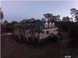 This Elegant custom built estate overlooking St. Joe Bay is one of, if not, the nicest homes in Port St. Joe. The home features over 7500 total sq ft and sits on over 1.7 acres with 265 feet fronting St. Joe Bay. The attention to detail on this home is extremely impressive with abundant millwork throughout, a beautiful floating spiral staircase, marble floors, executive chef's kitchen w/ Viking appliances, separate mother-in-law suite, incredible master bedroom and master bath, private pool, 3 car garage, wonderful porches, and way too many extras to list. Purchased for $1,900,000 and being sacrificed at an incredible value.