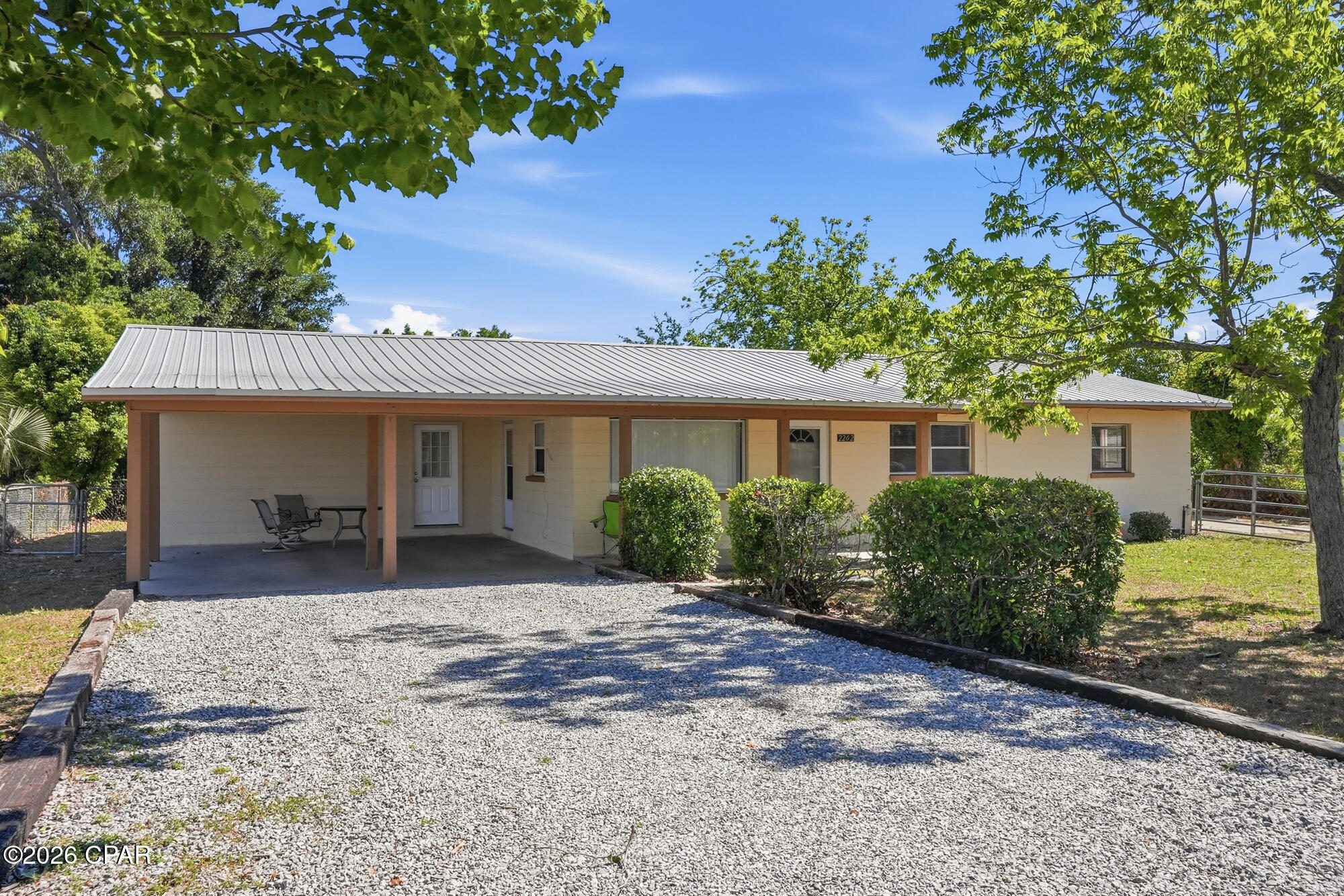 Situated on over half an acre, this solid concrete block 3-bedroom, 1-bath home offers the perfect blend of space, functionality, and flexibility with no shortage of room for your hobbies, animals, and equipment! With horses and livestock allowed, this property is ideal for those seeking a mini-homestead or extra room to spread out.  Recent updates include a durable metal roof (2018) and new PEX plumbing throughout the home, offering peace of mind for years to come. The property is connected to public water and sewer for added convenience.  Outside, the possibilities are endless with an impressive lineup of outbuildings and storage options, including a 12x50 enclosed pole barn/workshop with 15-foot clearance and 50-amp service, a 20x18 detached garage with roll-up door, an 18x40 RV port with 50-amp hookup, a 12x24 covered storage area, and an additional 12x24 storage shed. Whether you need space for an RV, boat, equipment, workshop, or business storage, this property has you covered.  The fenced yard provides security and privacy, while mature pecan trees add charm and character to the property. If you're looking for a versatile property with room for animals, toys, and projects, this one is a must-see!