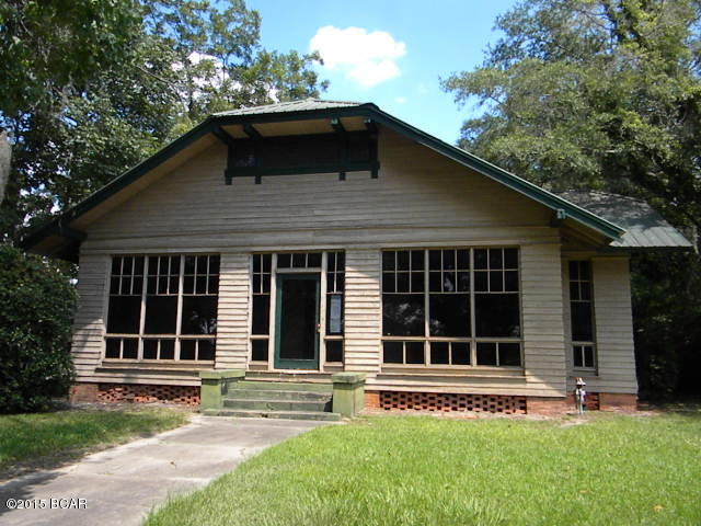 Charming century old home with 4 bedrooms and 2 baths, corner lot, hard wood floors, high ceilings,  lots of built in cabinets, enclosed wrap around porch with access to bedrooms, fenced yard, convenient to town.  Some updates done over the years however needing some work to make it a true southern bell.  You don't want to miss this one so call today.