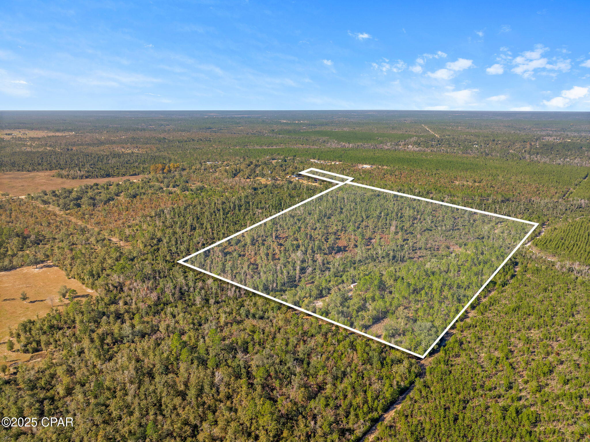 Escape to your own Northwest Florida retreat just 4 miles from Hwy 231. This heavily wooded 64± acres features two flowing creeks, two bridges for easy UTV/tractor passage, and multiple cleared areas ideal for a homesite or recreational use. Improvements include a 24'x24' pole barn (roofing materials on site), two Quonset hut kits ready to assemble for equipment/storage, a 16'x10' shed, and a temporary power pole in place for quick electric hook-up. Deeded, gated access--no access concerns.

With hunting season approaching, the mix of cover, creek corridors, and openings sets up nicely. There's room to establish food plots, expand an internal trail system, and create an RV/camper pad so you can enjoy the land now while planning your future build. Quiet, private, and convenient to the Hwy 231 corridor--this is a versatile property for recreation, homesteading, or a secluded country estate.