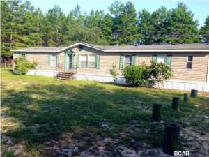 Don't miss this wonderful find! This home is a 5 Bedroom, 3 bath on over 3 acres of land. Home owner has had outside pressure washed and NEW carpet installed as of August 2014. The kitchen features a kitchen island, lots of cabinet space, and opens to a formal living room. Living room offers a fireplace and lots of natural light from large windows and sliding glass door leading to a large open deck which is perfect for grilling, a family get-together, or just relaxing in the warm Florida sun. This home offers a split bedroom plan with master bedroom and bathroom on one side of the home and all 4 additional bedrooms on the other side of the home. The master bedroom offers a large garden tub with separate shower and separated toilet room. If you are looking for land and large rooms and