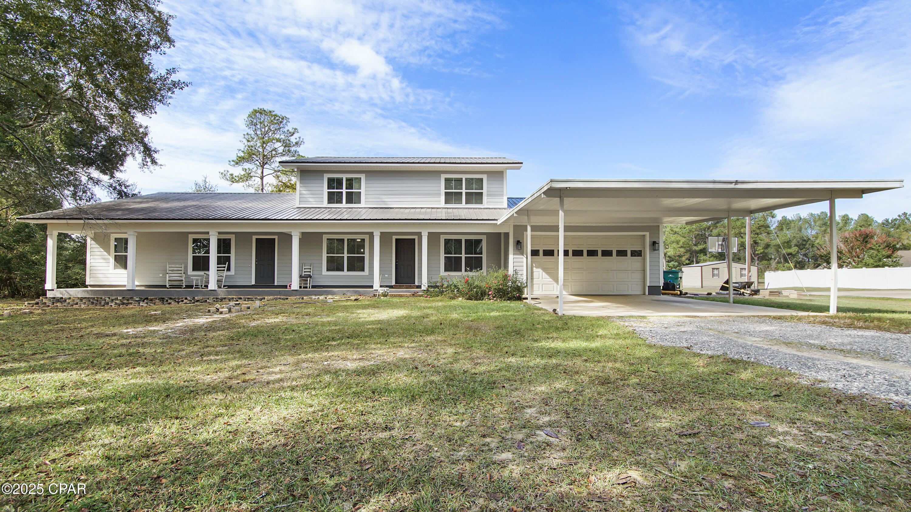 Mother-in-law suite special! This 6 bedroom, 4 bathroom house features a connected 2 bedroom suite with large living room, modern bathroom suite with granite counter tops, a tile walk-in shower, and an office for a total of approximately 1,200 square feet. A door separates the mother-in-law suite from the rest of the 2-story home that just had a major makeover that includes new windows, concrete Hardi board, new LVP in many areas, all 4 bathrooms updated, new water heater, new Square D electrical panel and breakers, new light fixtures and ceiling fans, remodeled stairs, new paint, kitchen upgrades include all new appliances, stainless deep sink and faucet, new subway tile backsplash, new butcher block counter tops, soft closing cabinet doors and handles, large pantry with shelves, and more under a metal roof. The well submersible pump was replaced in 2024. The master bathroom suite has a large step-in tub, a separate shower, and a big walk-in closet. The windows are covered with new faux wide plantation blinds. There is also a  20 by 20 concrete pad with new electric plug for a storage building in the flat back yard. It is less than a mile from Interstate 10, Super Walmart and Falling Waters State Park. It is convenient to schools, shopping, restaurants and a variety of businesses. It is less than one hour to the World's Most Beautiful Beaches in Panama City Beach and Pier Park. The 6 foot deep by 60 foot long front porch is covered and extends the length of the house. The covered back porch is almost as big, 8 by 22 and 10 by 30 with a door leading to the mother-in-law suite. This home is large enough for 2 families! The home is on a 2-acre lot but includes the adjacent vacant one-acre lot Parcel 00000000-00-2385-0034 for a total of 3 acres. View all of the photos with descriptions for more details.