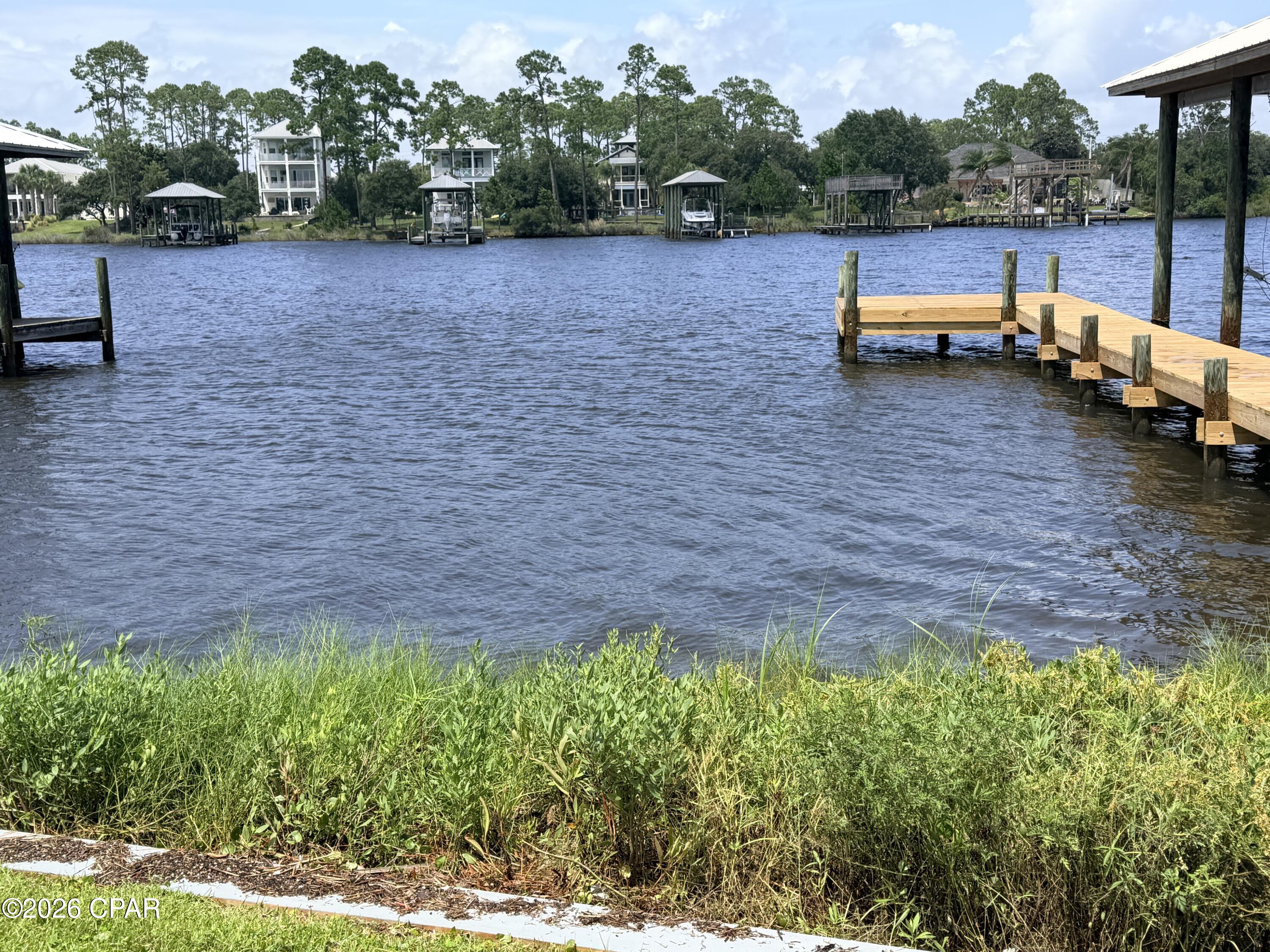 BRING YOUR BOAT! ** Lagoon-Front Lot in Holiday Beach - Gulf of America Access in Minutes!

Rare opportunity to own a **50' x 130' lagoon-front lot** in the sought-after **Holiday Beach** community, just **4 blocks to the sugar-white sands of the beach**. Build your dream home or getaway retreat on protected lagoon waters with Gulf of America access just minutes away.

This lot offers a peaceful, private setting on the water with a new boat dock already in place, fresh split-rail fence lining the frontage. Deep, calm lagoon water is perfect for kayaking, fishing, or launching a boat right from your own backyard. A public boat ramp just down the street makes it easy to get out on the water, and you're close to some of the best restaurants on the east end.
 

Whether you're building a primary residence, a second home, or an investment property, this lagoon-front lot combines coastal and boating convenience in one of Panama City Beach's most desirable areas.