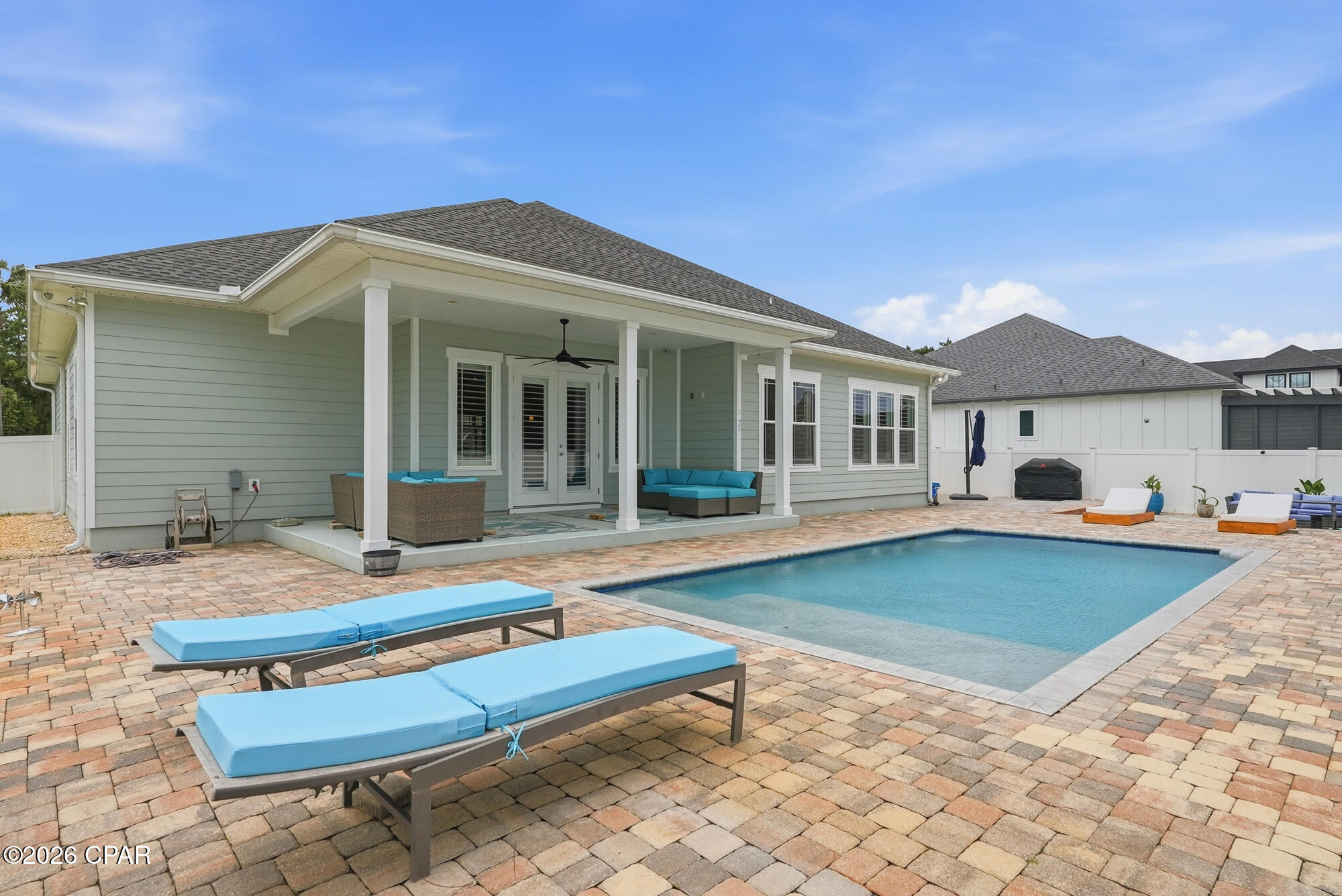 This remarkable home, located in the gated Dolphin Bay community, boasts a  glimmering view of the intercoastal waterway and Hathaway Bridge from the saltwater pool area and lanai. This craftsman style home, built in 2017, offers four bedrooms, three baths, a formal dining room, breakfast nook, and an inviting kitchen with an island perfect for entertaining. The large plantation style windows provide ample natural light and gorgeous views. Luxury finishes include porcelain wood tile flooring 12-foot ceilings, crown molding, and granite countertops throughout the home with beautiful tray ceilings in the Living room, dining room, and master bedroom.  Truly a must see! Roof 2017, HVAC 2025, Water Heater 2017, New coated garage flooring in 2023, new kitchen appliances in 2024, and all new grass and landscaping. Furniture is negotiable. 
Age, Sq ft. Dimensions  approximate and must be verified by buyer.