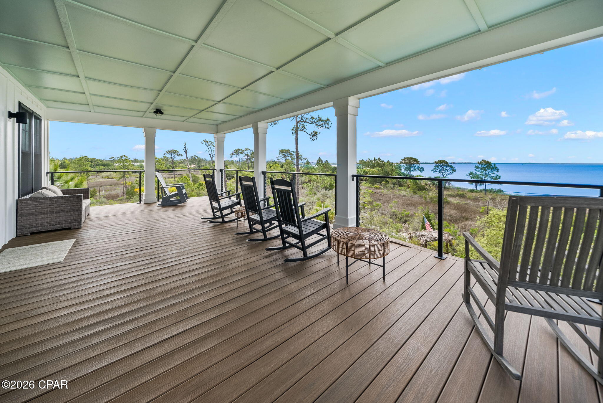 Experience refined coastal luxury on the shores of St. Joe Bay in this exceptional custom-built retreat located within the highly sought-after gated community of WindMark Beach in Port St. Joe, Florida.

Perfectly positioned to capture breathtaking bay views and unforgettable sunsets, this stunning residence blends timeless coastal architecture with high-end designer finishes and meticulous attention to detail throughout. Every space was thoughtfully curated to create a sophisticated yet relaxed waterfront lifestyle that today's luxury buyers and vacation guests are searching for.

Inside, the home showcases wide-plank flooring, custom millwork, shiplap accents, designer lighting, spa-inspired bathrooms, oversized windows, and a soft coastal palette that complements the natural beauty surrounding the property. The open-concept design was built for entertaining, seamlessly connecting the expansive living areas to oversized covered balconies overlooking St. Joe Bay.

Designed with both luxury and functionality in mind, the property features multiple guest suites, spacious gathering areas, and an incredible custom bunk room ideal for maximizing occupancy and short-term rental income potential. An elevator services multiple floors of the home, adding convenience and elevated appeal rarely found in coastal investment properties.

Outdoor living takes center stage with expansive covered porches, a private pool, and private beach access just steps away, allowing owners and guests to fully embrace the laid-back elegance of bayfront living. Whether spending the day on the water, relaxing poolside, or enjoying quiet evenings overlooking the bay, every aspect of this home was designed to deliver an unforgettable coastal experience.

Beyond the property itself, WindMark Beach offers one of the most desirable coastal lifestyles along Florida's Gulf Coast. This gated waterfront community is known for its pristine natural beauty, miles of walking and biking trails, resort-style community pool, fitness center, community gathering spaces, beach access points, and charming coastal village atmosphere. Residents and guests enjoy easy access to waterfront dining, boutique shopping, live music, marinas, boating, fishing, and the laid-back charm that has made Port St. Joe one of Florida's hidden gems.

Located along the pristine waters of St. Joe Bay, this property offers the rare combination of luxury craftsmanship, exceptional rental capability, resort-style amenities, and private coastal serenity -- making it an extraordinary opportunity for those seeking a premier waterfront investment or luxury vacation retreat along Florida's Gulf Coast.