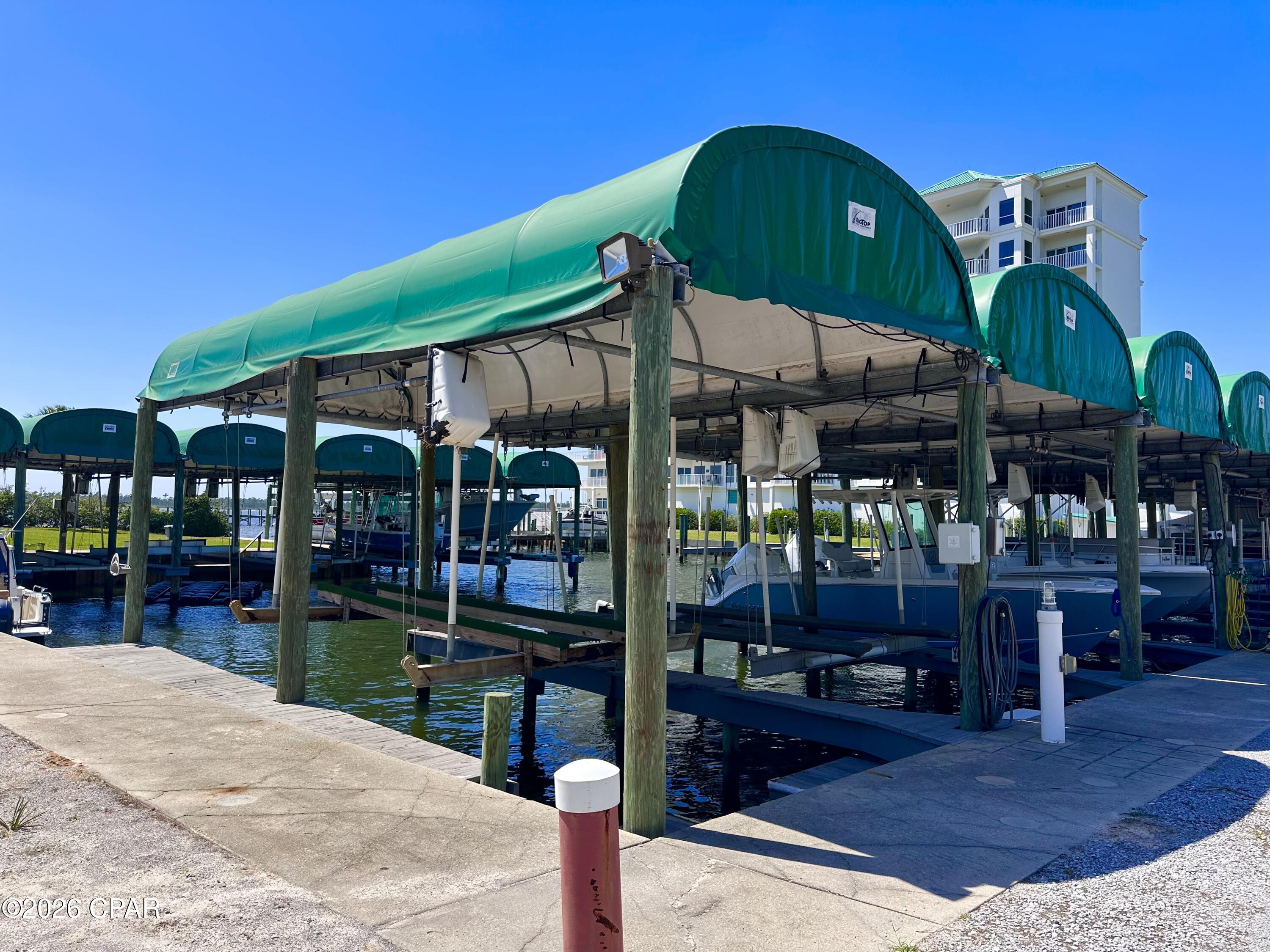 Luxury Waterfront Living with Deeded Boat Slip & Private Garage at Marina Bay! Welcome to one of the most beautiful and distinctive waterfront communities along the shores of Panama City--where luxury, privacy, and coastal living come together in spectacular fashion. This stunning corner residence at Marina Bay offers over 2,000 square feet of beautifully designed living space, complete with a deeded 30-foot covered boat slip, a private detached garage, and an additional covered parking space--an exceptionally rare combination for waterfront condo living. Inside, you'll be welcomed by a bright and airy open floor plan filled with natural light and framed by floor-to-ceiling windows showcasing breathtaking bay views from nearly every room. The spacious living area opens seamlessly onto a large bayfront balcony, creating the perfect setting for morning coffee with dolphin sightings or evening sunsets over the water. The beautifully remodeled kitchen has been thoughtfully reconfigured to maximize both style and function, featuring a large island, granite countertops, custom backsplash, stainless steel appliances, and abundant storage. Designed for privacy and comfort, the luxurious waterfront primary suite is tucked away from the guest rooms and features private balcony access, coffered ceilings, a spacious walk-in closet, and a spa-inspired bath with dual vanities, exceptional storage, a jacuzzi tub, and separate shower. The guest accommodations are equally impressive. One bedroom offers a private en-suite bath, coffered ceilings, walk-in closet, and marina-view balcony, while the oversized third bedroom features its own private entrance, tray ceiling with accent lighting, and walk-in closet--ideal as an in-law suite, office, or hobby space. Residents of Marina Bay enjoy a beautifully maintained, non-short-term-rental community with resort-style amenities including: Bayfront pool & hot tub, fitness center, private marina w/ boat slips, fishing pier, community room, and a private beach area. Recent community improvements include a newer roof, fresh exterior paint, resurfaced walkways, and a newly paved parking lot. Low HOA fees and healthy reserves help simplify maintenance, allowing you to enjoy a truly carefree waterfront lifestyle. Whether you're a boating enthusiast, full-time resident, or searching for a peaceful coastal retreat, this extraordinary property offers an unmatched blend of elegance, convenience, and bayfront beauty. Corner waterfront condos that include a covered boat slip and private garage rarely become available--schedule your private tour today!