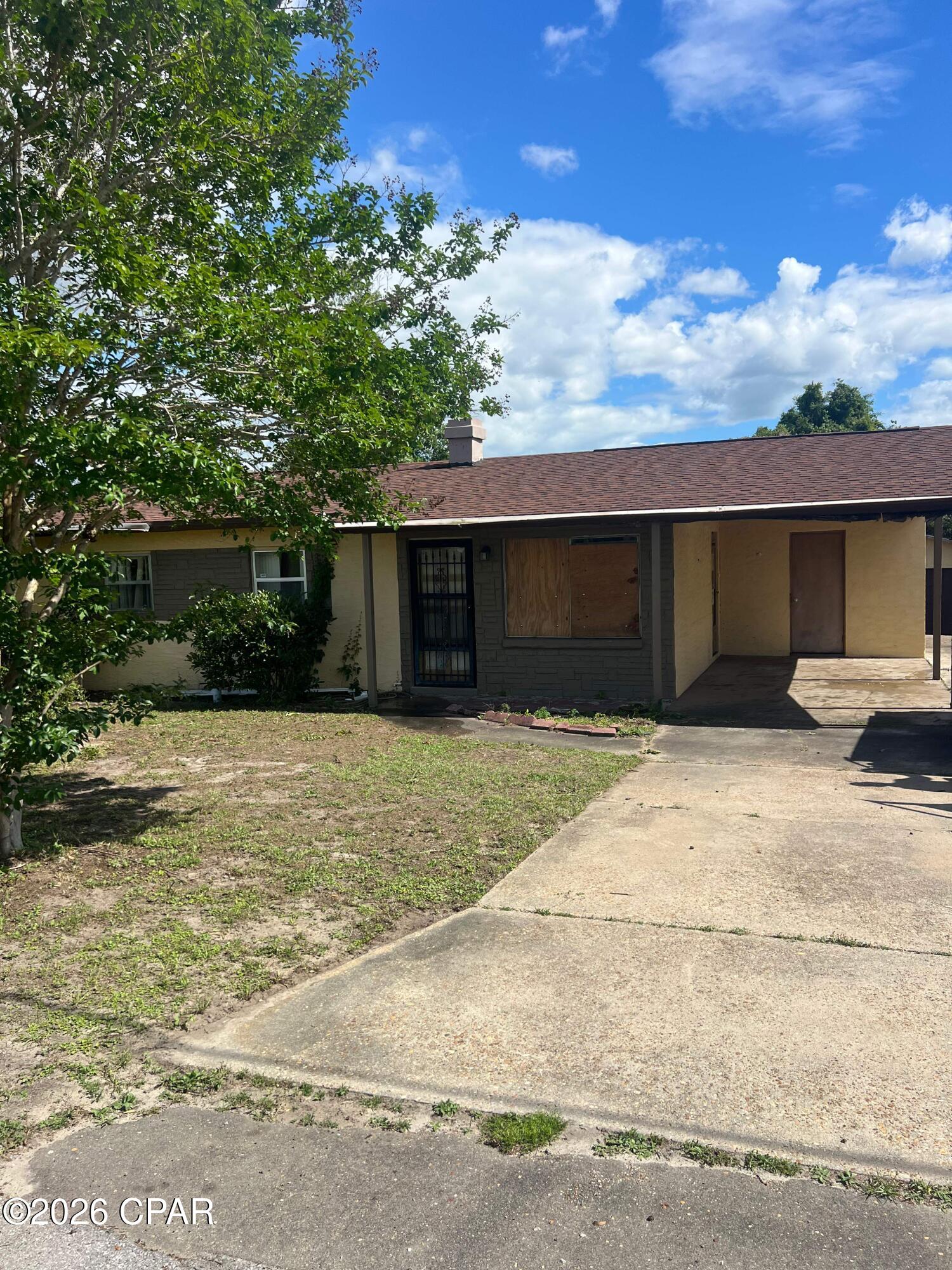 Opportunity awaits with this spacious 4 bedroom, 2 bathroom situated on an oversized lot near Panama City. Offering 1,504 square feet of living space, this home features tile flooring, a bright living and dining room combination, and a large family room with a cozy fireplace. The open kitchen includes a breakfast bar and overlooks the main living areas, creating a functional layout with plenty of potential. The primary suite features a private bath, while the additional bedrooms are spacious and filled with natural light. Outside, the detached garage provides added storage, workspace, or parking options, and the oversized yard offers room to expand or create your ideal outdoor space. Conveniently located just a short distance from downtown Panama City, shopping, dining, parks, and the beautiful Gulf Coast beaches. Perfect opportunity for investors, renovators, or buyers looking to customize a home in a great location. All information recorded in the MLS is intended to be accurate but cannot be guaranteed, buyer advised to verify. Sold As-Is