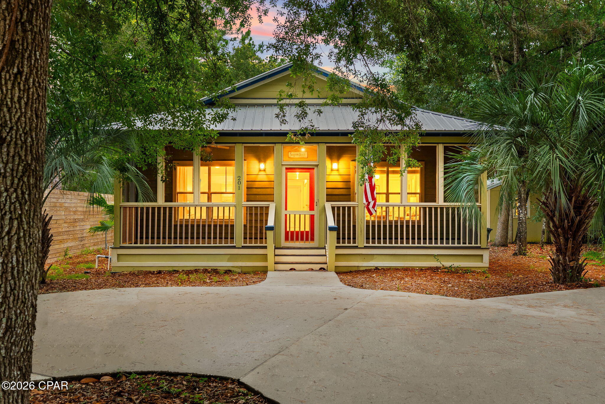 Nestled beneath a canopy of mature oaks in the highly desirable Point Washington community, this charming 3-bedroom, 3-bath coastal cottage offers the perfect blend of privacy, character, and convenience. Set on a wooded homesite just moments from Choctawhatchee Bay and the beaches of South Walton, this home embodies the laid-back Florida lifestyle.

Inside, vaulted ceilings, abundant natural light, and beautiful hardwood floors create an open and inviting living space. The kitchen features stainless steel appliances, ample cabinetry, and a breakfast bar overlooking the spacious living and dining areas, perfect for entertaining or everyday living. The split-bedroom floor plan provides privacy, while the primary suite offers a large walk-in closet and ensuite bath with a soaking tub/shower.

One of the home's standout features is the incredible screened outdoor living area, complete with a wood-burning fireplace, mounted TV, and porch swing, an ideal year-round retreat for relaxing or gathering with friends and family. Additional highlights include a metal roof, covered front porch, storage shed, and a private backyard surrounded by natural landscaping.

Located in the heart of Point Washington, residents enjoy easy access to bayfront parks, boat launches, hiking and biking trails, and the world-famous white-sand beaches of 30A. Whether you're searching for a primary residence, second home, or investment opportunity, this coastal cottage offers a rare combination of charm, privacy, and location.

Coastal living at its finest in one of Santa Rosa Beach's most beloved neighborhoods.
