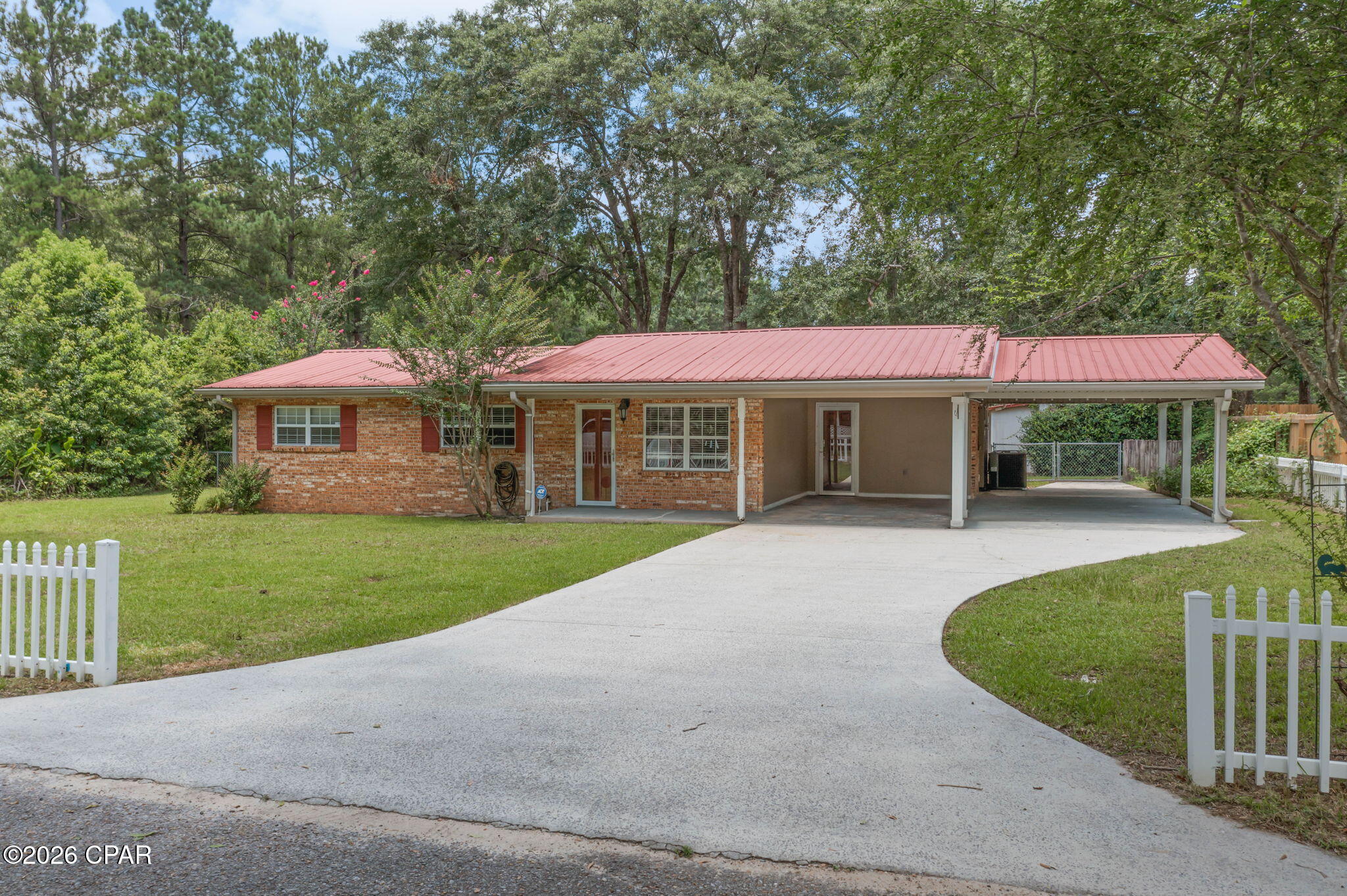 Beautifully updated brick home tucked away at the end of a quiet street in the heart of Bonifay. Recent improvements include quartz countertops, fresh interior paint, updated light fixtures, and all new flooring throughout the home. The kitchen features stainless steel appliances, a breakfast bar, and ample cabinet space. The versatile floor plan offers multiple living areas, including a spacious sunroom, two bonus rooms, and a unique primary suite featuring two walk-in closets and an additional connected space that could serve as a nursery, home office, sitting room, dressing room, fitness area, or private retreat. Outside, you'll find a metal roof, covered front porch, open patio, two-car carport, fenced backyard, and two large powered outbuildings. One offers endless possibilities as a hobby space, craft room, she shed, man cave, workshop, or additional storage and includes an attached covered lean-to. The second, larger building features a spacious workshop/storage area with shelving already in place, along with a generous covered area for equipment, projects, or additional storage. Conveniently located near shopping, dining, schools, and everyday amenities, this property offers modern updates, versatile living space, and exceptional storage both inside and out. Additional Features:

* Oversized bonus/flex room with closet
* Double-pane vinyl windows
* Updated electrical service with breaker panel
* Full-size washer and dryer included
* Laundry room with built-in cabinetry
* Gas range