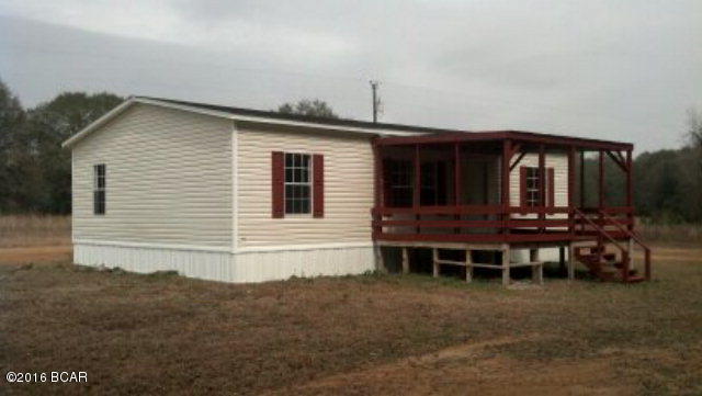 HUGE PRICE REDUCTION!! Extremely well kept home in the country with a few upgrades. Brand new carpet in the Living Room and all Bedrooms. New wood vinyl flooring in the Kitchen/Dining Room, Utility Room, and at Front Door. Freshly painted interior. Also comes with a new Refrigerator and Skirting. Home has a large 16'x 12' covered porch on the front to sit and enjoy the front yard with several nice, large oak trees. Only minutes from Greenwood, Grand Ridge, and Marianna. Drive by or call to make your appointment.