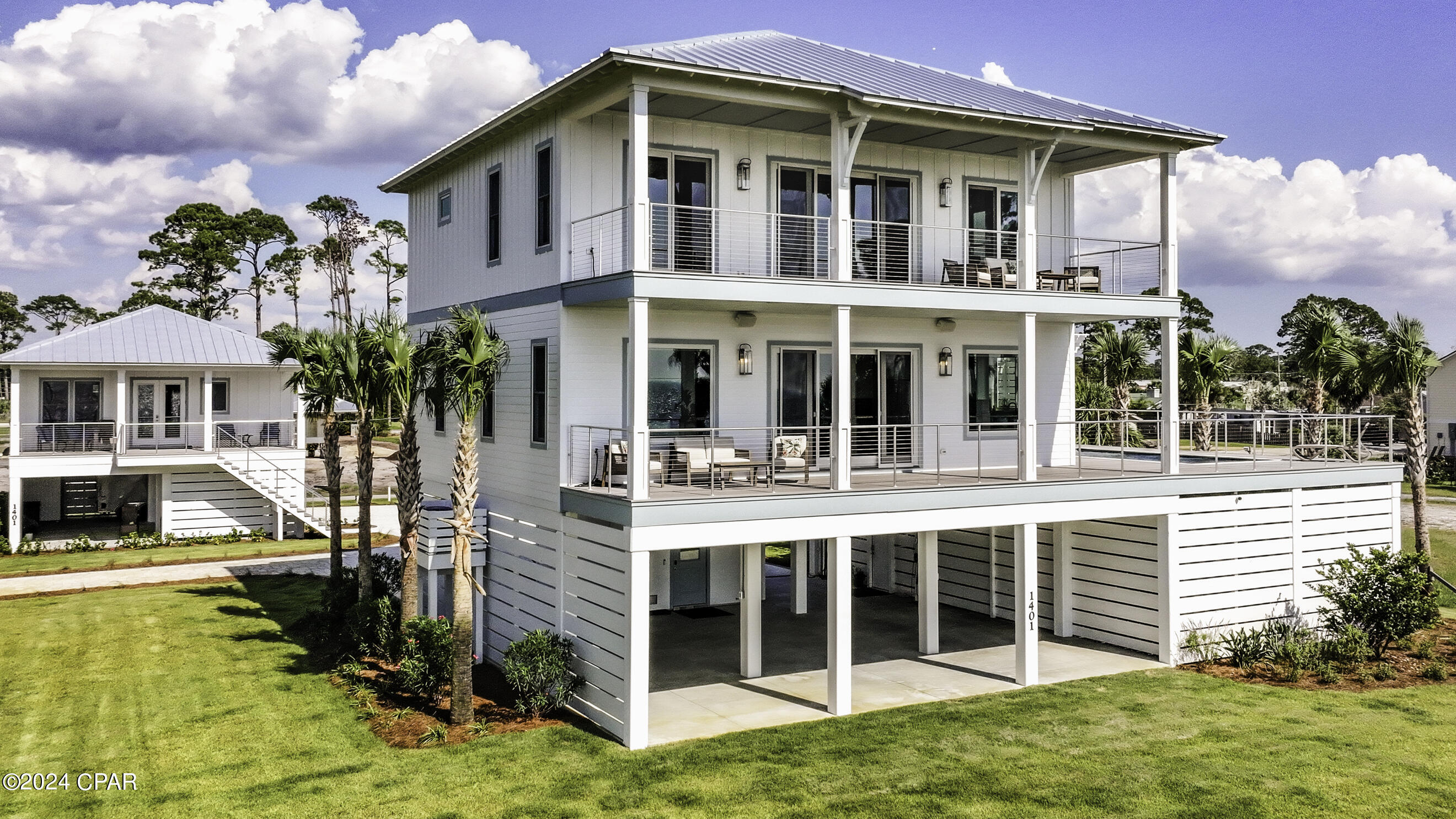 CURRENTLY UNDER CONTRACT, SELLER WILL CONSIDER BACKUP OFFERS. Welcome to your coastal oasis, a sprawling estate-sized property with breathtaking panoramic Bay views right in the heart of Port St. Joe! Built in 2023, this custom estate features a 3BR/3.5BA main house and 2BR/2BA furnished carriage house. The main house greets you with an elegant foyer and an elevator to take you to the first level where you enter the open living space with stunning Bay views, 10' ceilings and a wrap around deck.   Entertaining guests and hosting in your kitchen are made easy with an oversized quartz island, farmhouse sink, under mounted beverage fridge, ice maker, and stainless-steel appliances, including a gas cooktop. The adjacent dining area seats 8-10, while the living room offers a retreat for star gazing, sunset watching or curling up for a cozy night by the stacked stone fireplace. Step out to the elevated pool deck with a saltwater pool, bubbler, waterfall, and covered pergola with an outdoor kitchen. This level also includes a guest bedroom with ensuite, half bath, and sauna.  Upstairs, the primary suite oasis features Bay views, a sitting area with a mini bar, and a luxurious ensuite with a soaking tub and zero-entry shower. The private covered deck is ideal for sunset views or to take in the salt air breeze. This level also includes an office, Jack and Jill bathroom, third guest bedroom, and a spacious laundry room. The home includes an AquaPro water filtration system, storage for pool equipment and water gear, and additional A/C-powered storage.  The carriage house mirrors the main home's style with 10' ceilings, a large deck, and breathtaking Bay views. Check out the 3D video tour!!  
Enjoy a golf cart-friendly lifestyle in this vibrant community, where you can effortlessly cruise to nearby shopping, dining, and the beach! Port St. Joe is a hidden gem on the Gulf Coast that offers a unique blend of small-town charm and stunning natural beauty.  Food lovers will appreciate the variety of fresh seafood, local cuisine & waterfront dining at the local establishments that offer a cozy atmosphere.  Visit the St Joseph Peninsula State Park on Cape San Blas to hike, fish, birdwatch or just relax on the beach enjoying the stunning scenery. If you're seeking a beautiful place to live that offers both adventure & serenity, don't delay-call our office to book your private tour!!