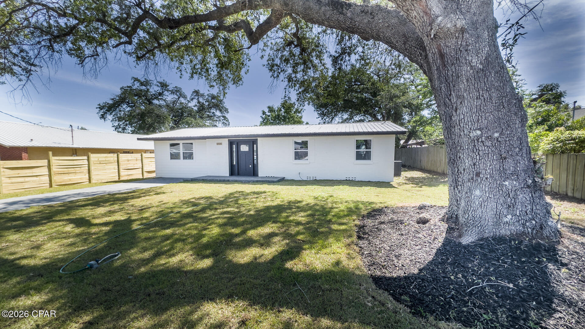CURRENTLY UNDER CONTRACT, SELLER WILL CONSIDER BACKUP OFFERS. Discover this beautifully updated home in the heart of historic St. Andrews, perfectly positioned on a spacious lot shaded by majestic heritage oak trees. Just steps away from waterfront dining, the marina, boutique shops, parks, and vibrant local amenities, this home offers the ultimate blend of classic coastal charm and modern convenience in one of Panama City's most desirable neighborhoods.

Arrive via a handsome paver driveway to a welcoming front porch featuring fresh paint, all-new windows, and a striking custom front door. The durable concrete block construction and  metal roof ensure long-term peace of mind, while the location means no flood insurance is required.

Step inside to an impressive open-concept living area anchored by a cozy electric fireplace with custom accent surround. The updated modern kitchen features a large breakfast bar that overlooks the living and dining spaces, creating a perfect flow for entertaining and everyday living. All-new luxury vinyl plank flooring runs throughout the home, complemented by modern LED recessed lighting with soft halo backlighting and upgraded fixtures for a bright, contemporary feel. A convenient walk-in utility room offers backyard access and connects to a small private patio--ideal for morning coffee or outdoor grilling.

The thoughtful split-bedroom floor plan delivers privacy and comfort. The spacious primary suite features dual closets and a luxurious walk-in shower. Two additional guest bedrooms share a well-appointed bathroom conveniently located just off the living area.

A large, fully fenced backyard is a true highlight--offering plenty of room for a future pool, playground equipment, boat/RV parking, or simply relaxing under the oaks. A storage shed is included for added convenience.
This home lives like new thanks to a comprehensive list of updates including: stainless appliances, new air conditioning system, new attic insulation, lighting and plumbing fixtures, windows, doors, paint, floors, and more. 

Whether you're looking for a primary residence, vacation home, or investment property, this move-in-ready gem delivers classic St. Andrews character with today's modern amenities and low-maintenance living. Enjoy easy access to everything Panama City, St. Andrews, and Panama City Beach have to offer--beaches, boating, dining, and more. Don't miss your opportunity to own this rare find in one of Panama City's most charming waterfront communities.