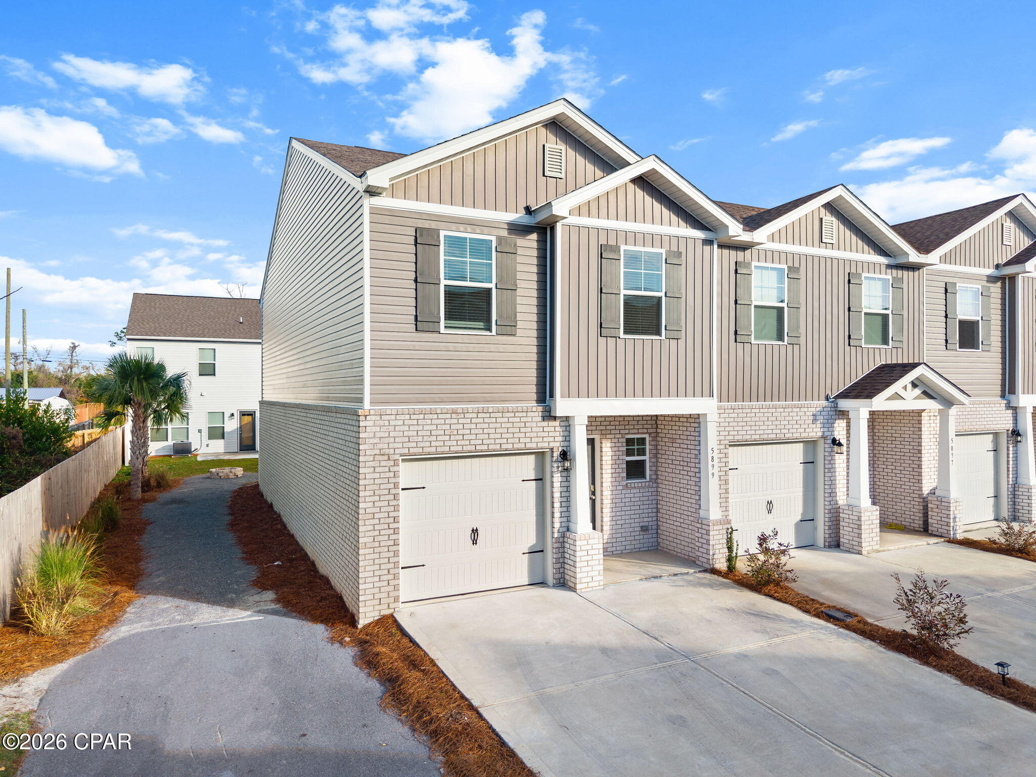 Welcome to 5899 Tyndall Place. This charming end-unit townhome offers 3 bedrooms, 2.5 baths, and a private one-car garage. LVP flooring runs throughout the entire home, giving it a clean, modern feel with easy maintenance. Designed with simple lines and thoughtful details, this home is both comfortable and functional. It's conveniently located just minutes from Panama City's white sandy beaches, shopping, dining, and local attractions, and within a short drive to Tyndall Air Force Base, making it ideal for work-life balance.  Whether you're a first-time homebuyer or an investor, you'll appreciate the peace of mind that comes with owning a new home. The surrounding area continues to grow, with new development and community improvements adding long-term value.  Enjoy nearby parks, everyday conveniences, and an easy commute, all while living in a stylish and well-located home. Don't miss the opportunity to make this one yours. Contact your Realtor today to schedule a private showing.