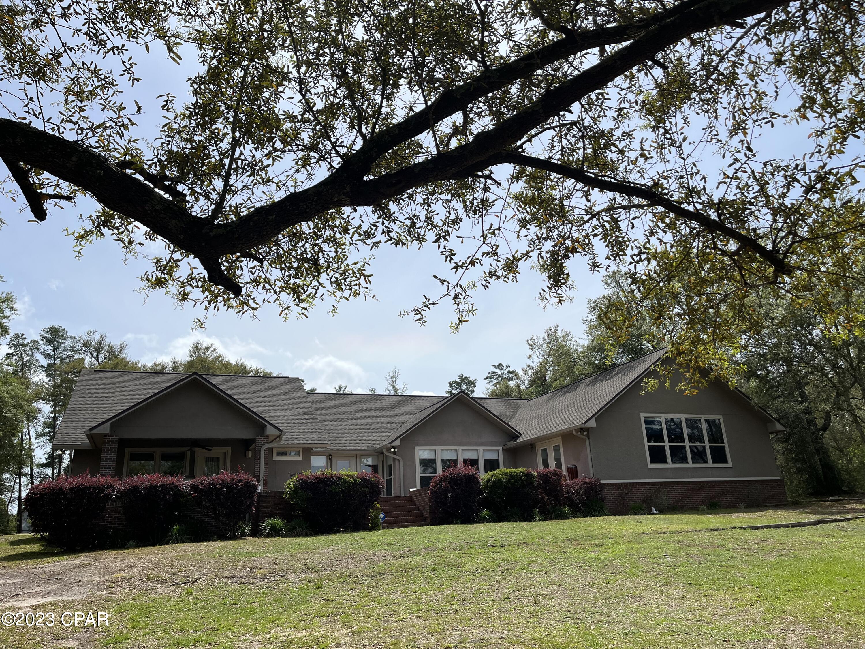 CURRENTLY UNDER CONTRACT-SELLER WILL CONSIDER BACKUP OFFERS
WELCOME HOME to BEAUTIFUL White Western Lake!  This wonderful property has 130' of lake shore on this PRIVATE lake that is spring fed & is crystal clear with a white sandy bottom.  Enjoy boating, jet ski's, tubing & fishing in your backyard!  View sunrises and sunsets from your patio. This home has been kept in PRISTINE condition!  The open floor plan allows views of the lake from the great room, kitchen and dining area.  You also get lake views from both of the 2 master suites.  BONUS  ROOM over the garage (great for an office or game room) The home has a 2 car garage & attached 2 car carport, dock with boat lift, storage bldg, outdoor shower.  Home is 1 mile to grade A school that is PreK-12th grades. 15 min to shopping & dining,  & 25 min to the World's Most Beautiful Beach & Pier Park. The grand Master Bedroom of this home features 4 large windows to take in gorgeous views of the lake. Enjoy family time on the huge 1100 sf concrete stained patio, which has a covered section that is perfect for dining.  This lake home could be an income producing B n B and could easily accommodate 3 families.  This home gives you the privacy you desire and feeling of country living but the convenience of being only a 15 minute drive to Lynn Haven for all your shopping needs, 20 minutes to Panama City,  & 20 min to the Airport.  Properties on White Western Lake rarely become available to purchase! Come and view this gorgeous property today!
* NEW ROOF in 2018 with hurricane clamps. 
* NEW HURRICANE EXTERIOR DOORS in 2019. 
All measurements are approximate, please verify if important.