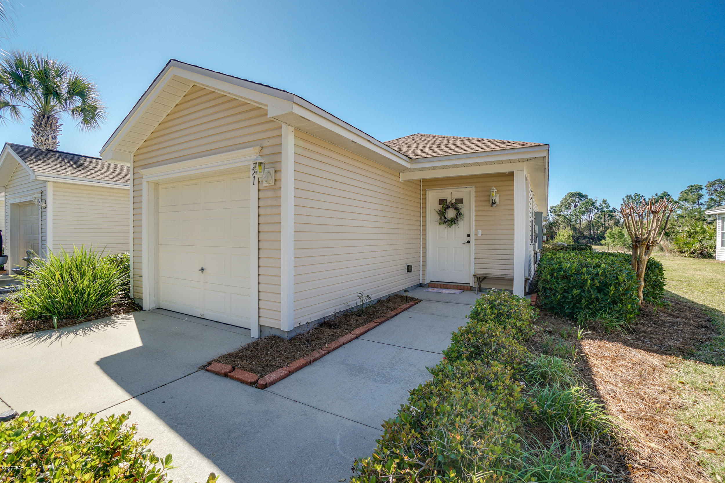 **Currently under contract but Seller will consider back up offers** Beautiful end unit townhome in Palmetto Trace. This 2BR/2BA unit comes with a 1 car garage, and screen porch overlooking  a pond. The open floor plan townhome features no carpet anywhere in the home. The Eat- in Kitchen features stainless appliances,  painted cabinets, and a breakfast bar. The master suite includes bathroom with double sink vanity, walk-in shower,  and double closets. This end unit allows for maximum natural light in the home. 

This is almost maintenance free living; HOA fee covers lawn care, irrigation, termite bond, annual pressure washing, twice a year pine straw application in yards, and trash collection. Palmetto Trace features tree lined street with sidewalks and streetlamps. The community includes 2 swimming pools with open air pavilions and bathhouses. Palmetto Trace is conveniently located a short ride or walk to Pier Park, Frank Brown Sports and Entertainment complex, Gayle's Trails, and the world's most beautiful beaches and Gulf of Mexico. You can live, work, and play all in the same area.

All room sizes, square footage, lot sizes are approximate; buyer to verify if important.

Buyer to pay St Joe charity fee- 1/2% of of purchase price