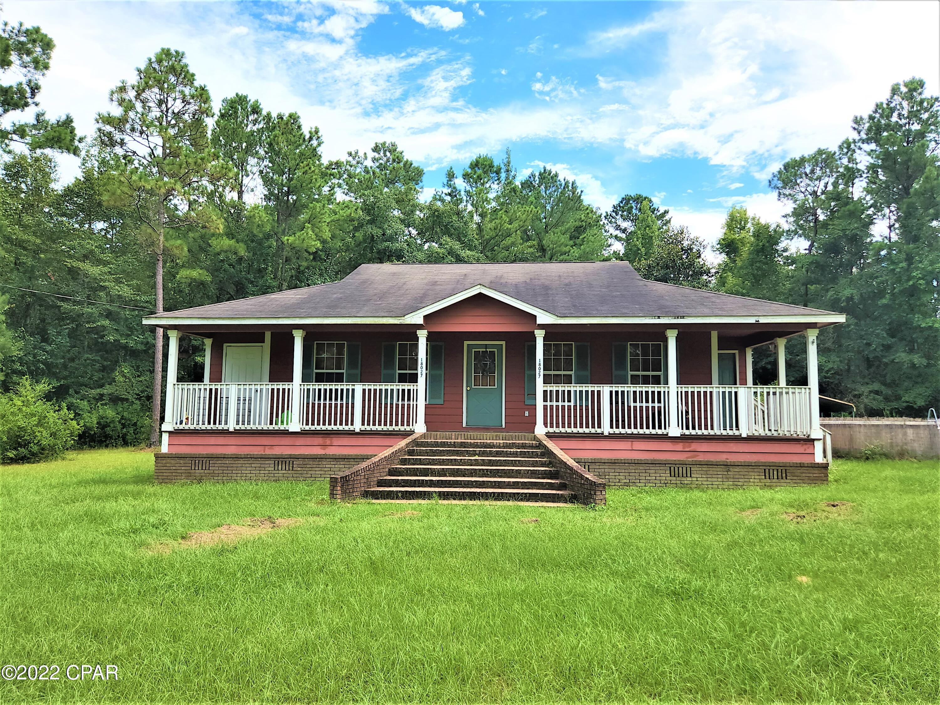 CURRENTLY UNDER CONTRACT, SELLER WILL CONSIDER BACKUP OFFERS. 

 Awesome country home with acreage and a large workshop.  This 3 bedroom 2 bath home has the privacy you are looking for as well as a 4 bay workshop that has two bays enclosed with wiring and studs for either a man cave or possibly completed into a studio apartment.  The grand stairs bring you up to a porch that runs the width of the house with plenty of room for rocking chairs to watch the deer from.  There is a storage closet at the left end of the front porch and a utility room entrance from the right side of the porch.  Inside you will find nice wood features throughout home.  If you have been wanting a home with land in a private setting yet less than an hour to Tallahassee this is it.