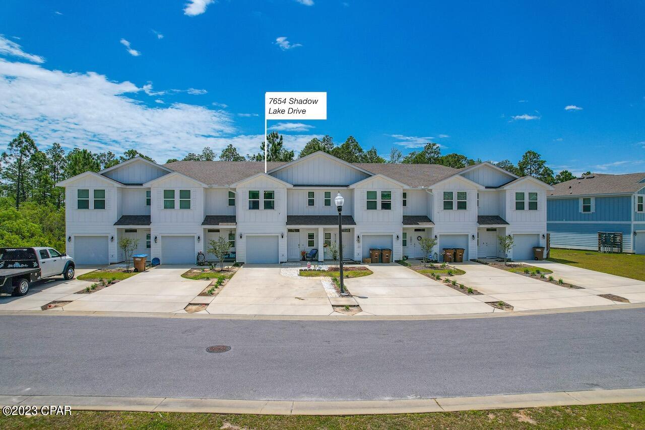 Amazing opportunity to own this Pond-Front, furnished townhome built in 2020. STR allowed with projected ROI of $50k+! This like new SMART home has great location in the complex with stunning water views from master bedroom and front porch.  The home is only 150Ft from the gated pool, close to the beach, easy access to HWY 98, Navy base, Sports Complex, grocery stores, night life and more. As you enter you have beautiful luxury vinyl plank flooring, granite countertops in the kitchen with SS appliances, backsplash, hard wood stairs etc. Upstairs you have a master bedroom with a walk-in closet, shower, double vanity and a Beautiful View of the pond. Extended deck with custom built grill station. A smart home package is included with skybell doorbell camera, touch panel and KwikSet key-less entry. 3 Driveway spaces + 1 car garage. It will be a perfect primary residence, second home or vacation rental! Low HOA that includes ground keeping, outside insurance, pool, accounting, trash pick up and maintenance of the common areas. This won't last long!