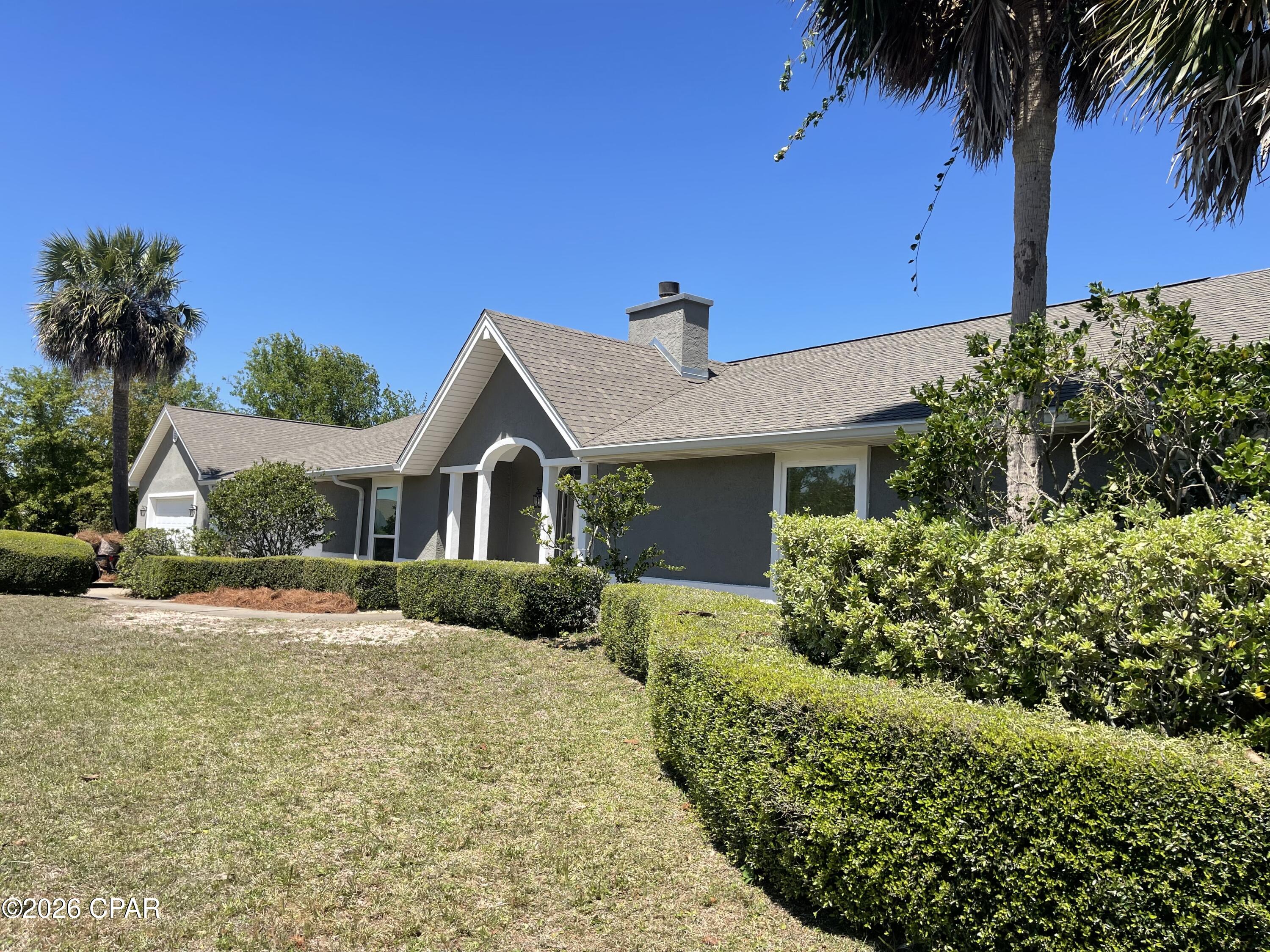 Nestled on a spacious 0.83-acre lot in the heart of Lynn Haven, Florida, this home offers a perfect blend of comfort and space. For those who love to entertain, there's a spacious 30x40 pole barn and a lovely patio area for outdoor gatherings. Additionally, the property includes 2 garages (one attached to the home and the other detached) spacious enough to accommodate up to six cars, along with ample driveway parking.
  Inside, this home features a cozy fireplace and a stunning sunroom that offers picturesque views of your custom saltwater pool. To add to the tranquility of the back yard, a rock waterfall feature in the landscaping is perfect for quiet times in the evening. For those who love to cook, the spacious kitchen is a dream come true, featuring double ovens, a large farmhouse sink, custom cabinets, and brand-new stainless-steel appliances. You'll also enjoy a generously sized laundry room and pantry area with plenty of space for supplies, and a stackable washer and dryer that convey with the property. You will also find spacious bedrooms and luxurious en suite bathrooms with custom walk-in showers. To top it all off, the AC system, heat pump, water heater and pool pumps are all high efficiency meaning this home can save you $$$$ on electric bills. The all-new AC system has all new ductwork and is completely balanced with return air in all rooms.  
 Situated on a corner lot in one of Lynn Haven's most sought-after subdivisions, this home truly has it all.