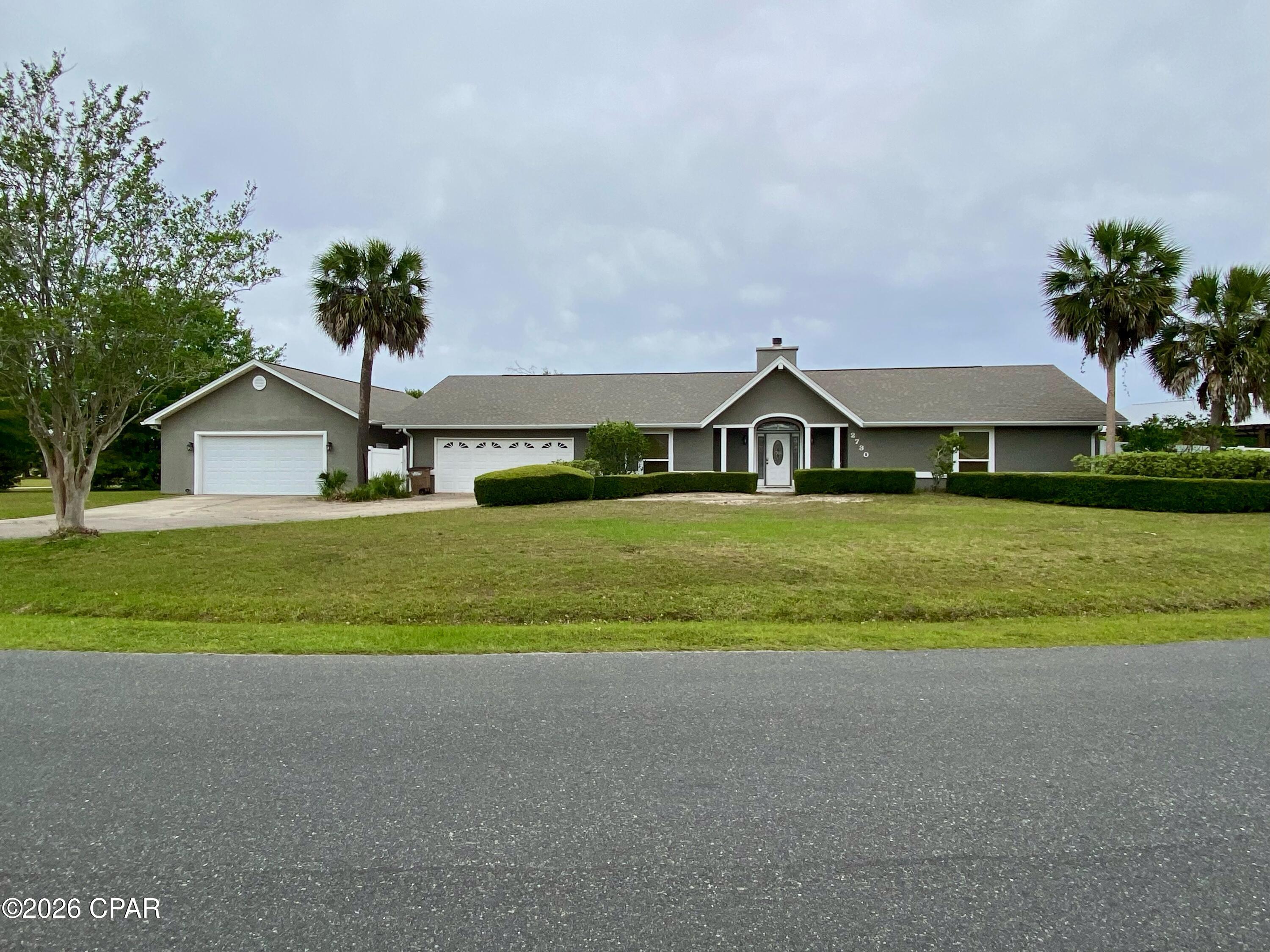 Nestled on a spacious 0.83-acre lot in the heart of Lynn Haven, Florida, this home offers a perfect blend of comfort and space. For those who love to entertain, there's a spacious 30x40 pole barn and a lovely patio area for outdoor gatherings. Additionally, the property includes 2 garages (one attached to the home and the other detached) spacious enough to accommodate up to six cars, along with ample driveway parking.
  Inside, this home features a cozy fireplace and a stunning sunroom that offers picturesque views of your custom saltwater pool. To add to the tranquility of the back yard, a rock waterfall feature in the landscaping is perfect for quiet times in the evening. For those who love to cook, the spacious kitchen is a dream come true, featuring double ovens, a large farmhouse sink, custom cabinets, and brand-new stainless-steel appliances. You'll also enjoy a generously sized laundry room and pantry area with plenty of space for supplies, and a stackable washer and dryer that convey with the property. You will also find spacious bedrooms and luxurious en suite bathrooms with custom walk-in showers. To top it all off, the AC system, heat pump, water heater and pool pumps are all high efficiency meaning this home can save you $$$$ on electric bills. The all-new AC system has all new ductwork and is completely balanced with return air in all rooms.  
 Situated on a corner lot in one of Lynn Haven's most sought-after subdivisions, this home truly has it all.