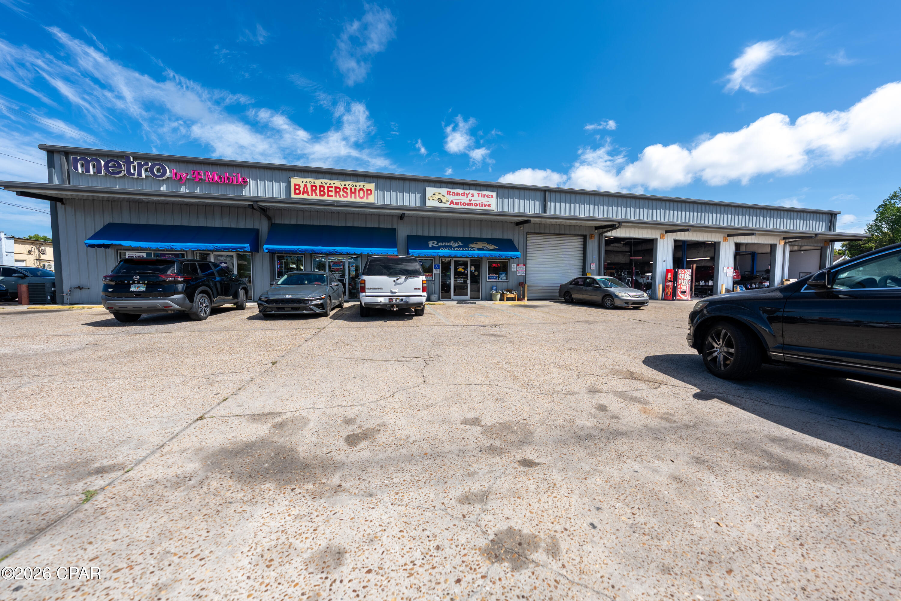 Prime commercial opportunity just minutes from Panama City Beach, positioned on a high-traffic corridor with excellent visibility and corner lot access.

This versatile property features three total units, anchored by a well-established, turnkey tire and auto repair center. The main unit is fully equipped and operational, boasting five bay doors, professional-grade lifts, compressors, and all necessary equipment included in the sale--offering a seamless transition for an owner-operator or investor.

In addition to the primary business space, the property includes two income-producing rental units with long-term tenants already in place, providing immediate and stable cash flow. One of the rental units also benefits from an additional bay door, enhancing functionality and appeal for automotive or light industrial use.

A standout feature is the expansive, fully fenced outdoor area ideal for auto storage, fleet parking, or expansion opportunities--adding significant value and flexibility to the site.

With strong frontage, steady traffic counts, multiple income streams, and a turnkey operation included, this property presents an exceptional investment opportunity in a rapidly growing coastal market.