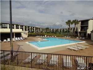 Sought after 2 bedroom 2 bath ''C'' unit in one of the few ''Low-Rise'' Gulf Front condos on the beach. No driving around a large multi-floor parking lot looking for a space, no waiting on slow overcrowded elevators. Park with-in a few yards of your unit. Ease of access as Unit is located on top floor, ( 2nd floor of steps). Other than carpet in bedrooms, unit is nicely tiles throughout. Although unit is not directly Gulf Front in the complex, this unit affords a fantastic Gulf View and overlooks the fresh water lake, swimming pool and clubhouse. Complex is located within walking distance of shopping, restaurants, family entertainment and nightclubs. Unit being sold ''As-Is''