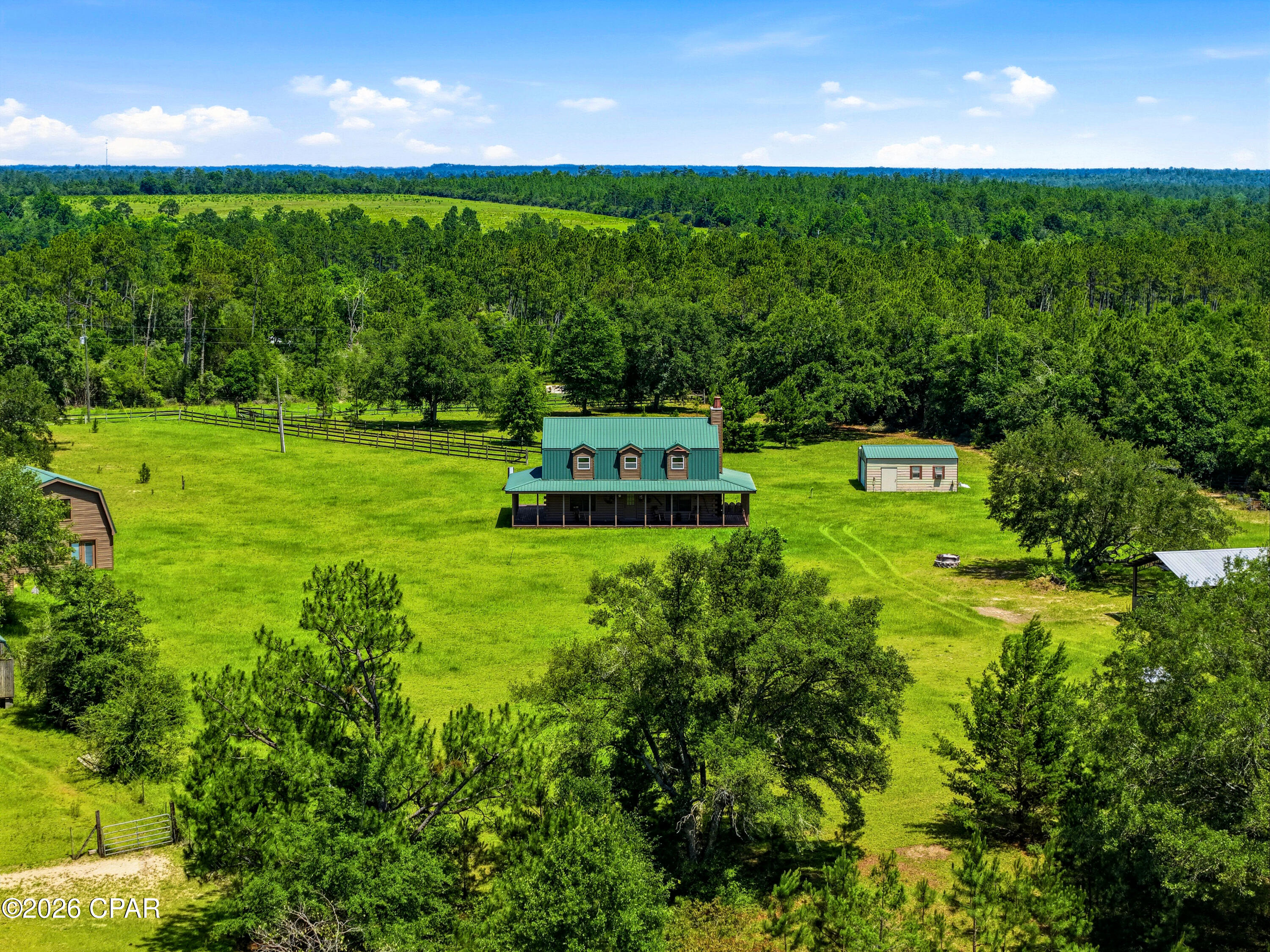 This 170± acre property in Jackson County, Florida offers a rare combination of comfortable living, recreation, and privacy. Whether you're looking for a full-time residence, family retreat, or hunting property, this tract has the improvements and acreage to support a variety of uses.

The property features a 3-bedroom, 2.5-bath home with approximately 1,920 square feet of heated and cooled living space, along with a separate 2-bedroom, 1-bath guest home that is ideal for extended family or guest. Beautiful oak trees surround the homes, creating a peaceful setting to enjoy the outdoors.

A well-maintained road system provides access throughout the property, making it easy to navigate by truck, ATV, or side-by-side while allowing you to fully enjoy all 170 acres.

Water is one of the property's standout features. Three ponds are located throughout the tract, including one with a small cabin equipped with power, water, a kitchen, and a full bathroom. Two creeks also run through the property, enhancing both the scenery and wildlife habitat.

The property has a strong history of deer and turkey hunting, with multiple established stand locations already in place. The combination of timber, ponds, creeks, and natural cover provides excellent habitat for wildlife and year-round recreational opportunities.

Additional improvements include a 36' x 24' pole barn with power, water, a fireplace, and sink, creating a great space for entertaining, equipment storage, or gathering with friends and family after a day outdoors.

With two homes, three ponds, two creeks, extensive internal roads, and proven hunting opportunities, this property offers a unique opportunity to own a private retreat in one of Northwest Florida's most desirable rural areas.